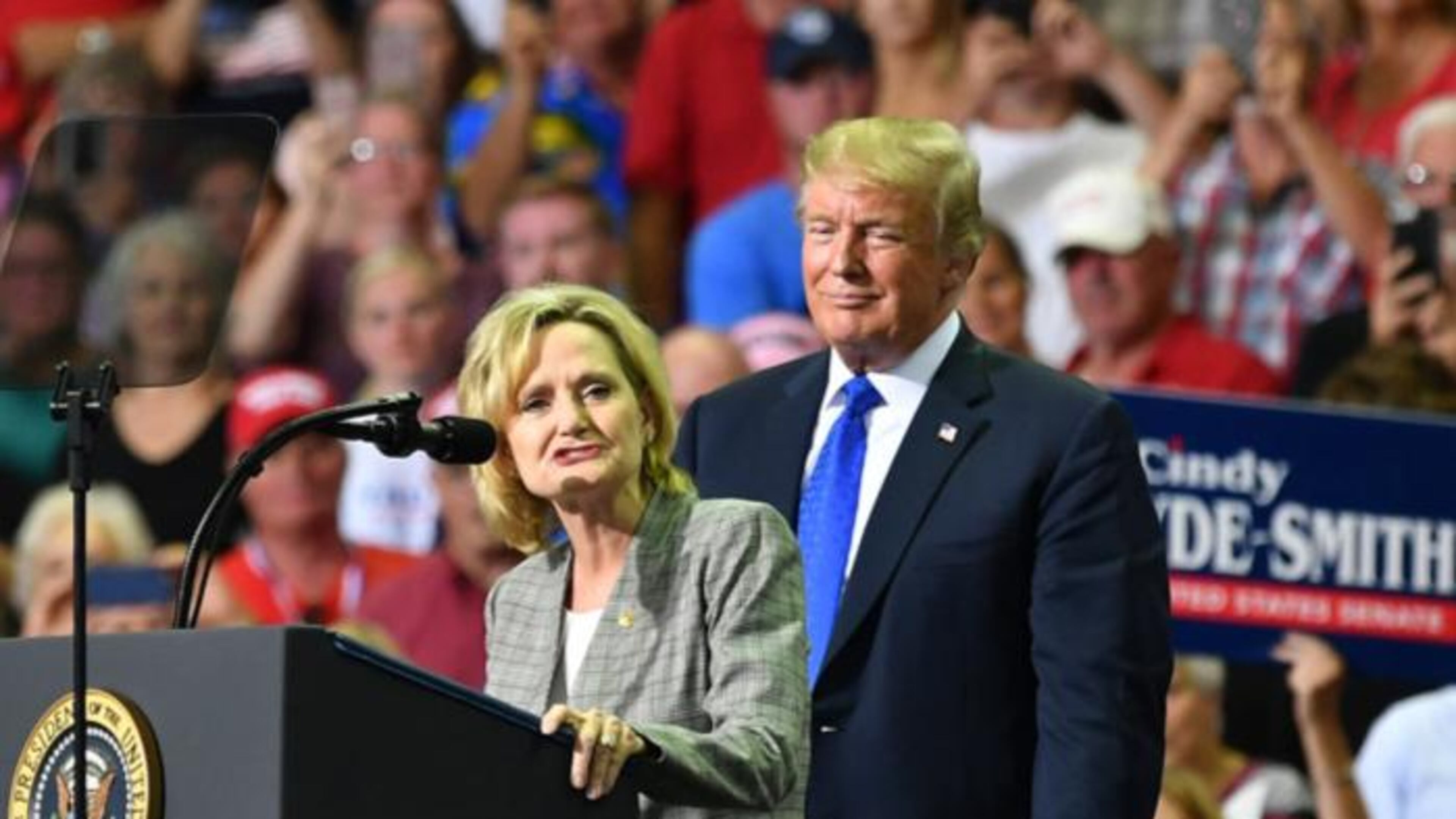 Mississippi Sen. Cindy Hyde-Smith (L) stands on stage with President Donald Trump at a “Make America Great Again” rally at Landers Center in Southaven, Mississippi, on October 2, 2018.