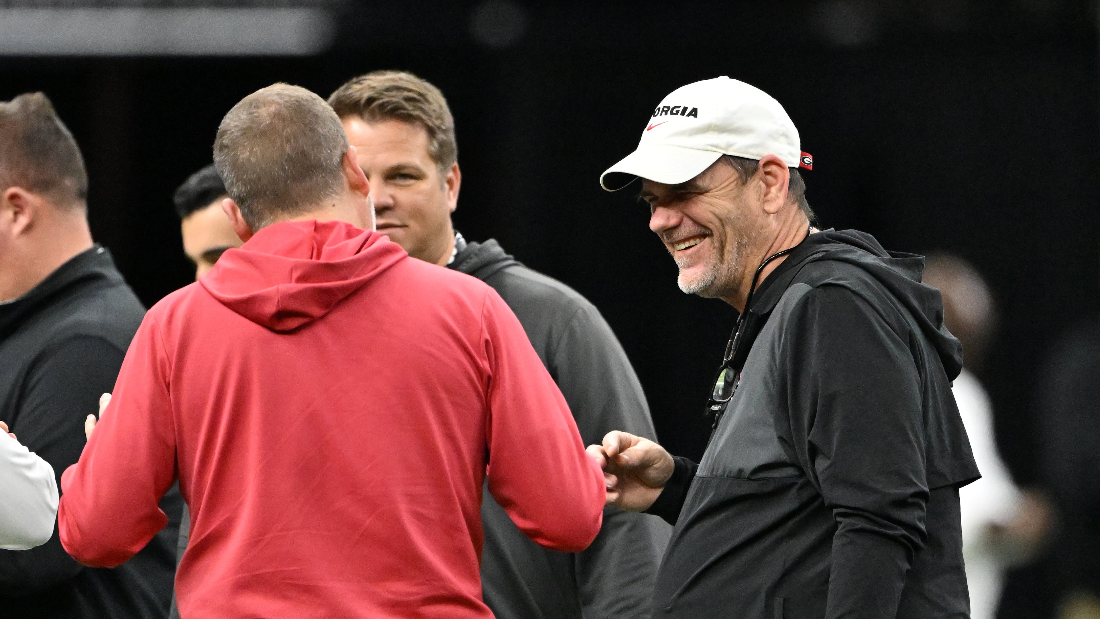 Bulldogs offensive coordinator Mike Bobo (right) — pictured during Sugar Bowl practice in December — and defensive coordinator Glenn Schumann received raises this offseason and will make $2.2 million for the 2026 season. (Hyosub Shin/AJC)
