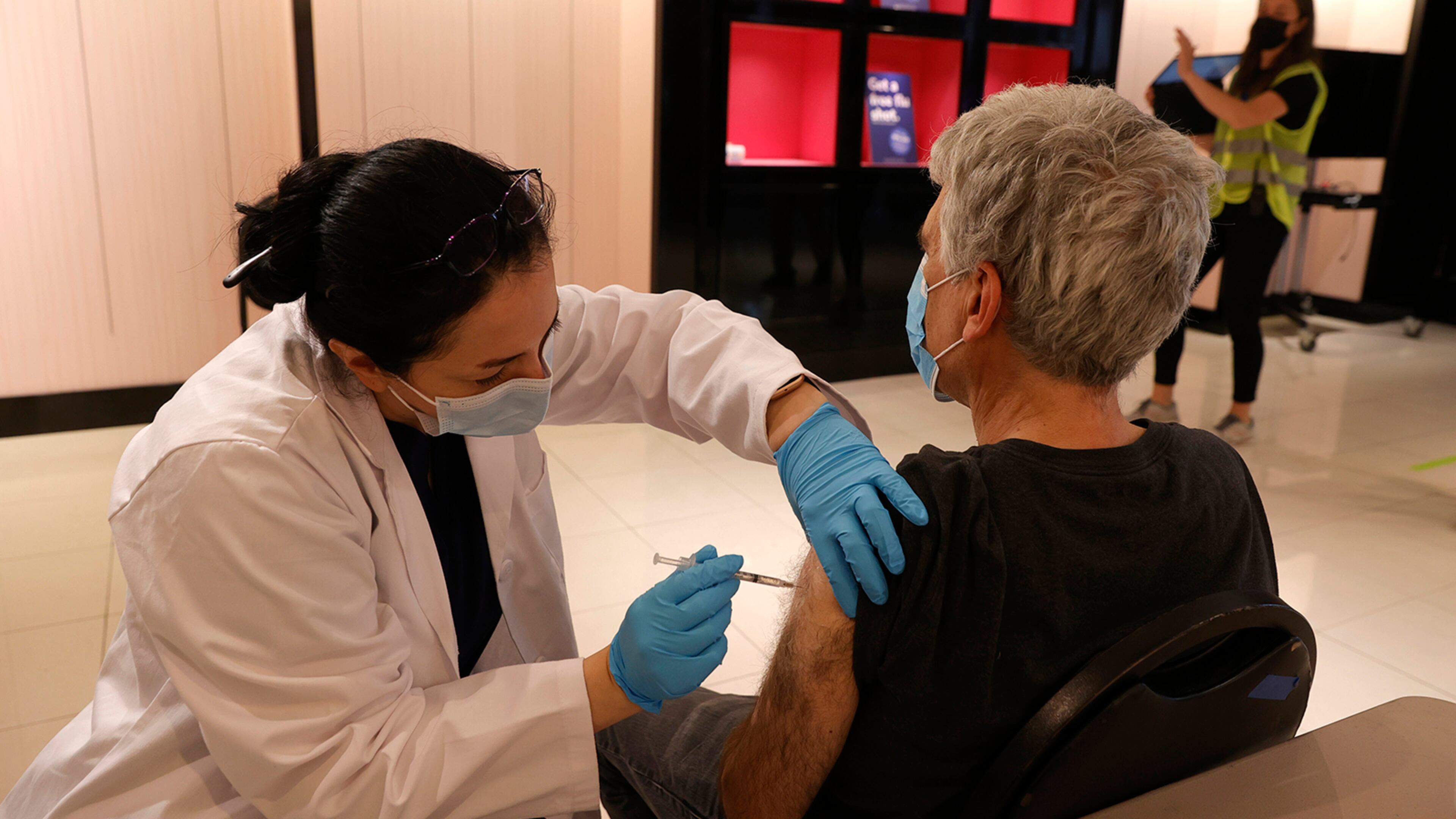Safeway pharmacist Shahrzad Khoobyari administers a Pfizer COVID-19 booster vaccination into the arm of Norman Solomon at a vaccination booster shot clinic on Oct. 1, 2021 in San Rafael, California. (Justin Sullivan/Getty Images/TNS)