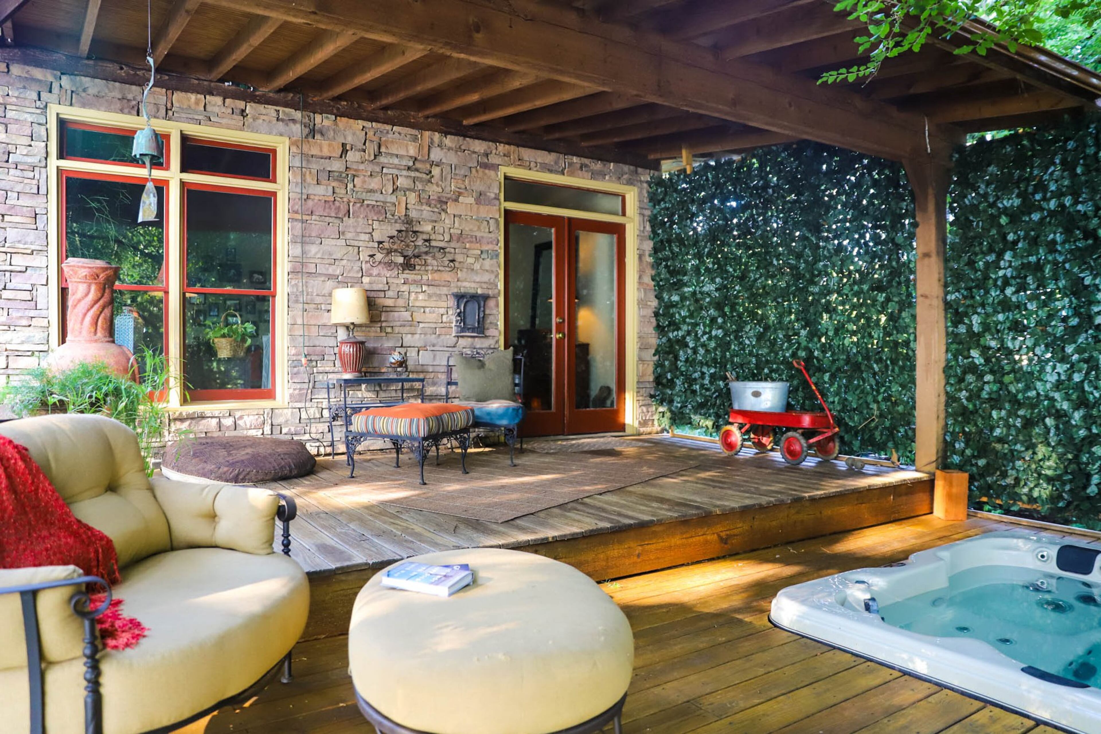 David Sellers built the deck off the master bedroom as a Christmas gift for his wife, Megan Sellers, a few years ago. The secluded space has a sitting area and a hot tub with doors that open right into their bedroom. Text by Shannon Dominy. Photo by Reynolds Rogers.