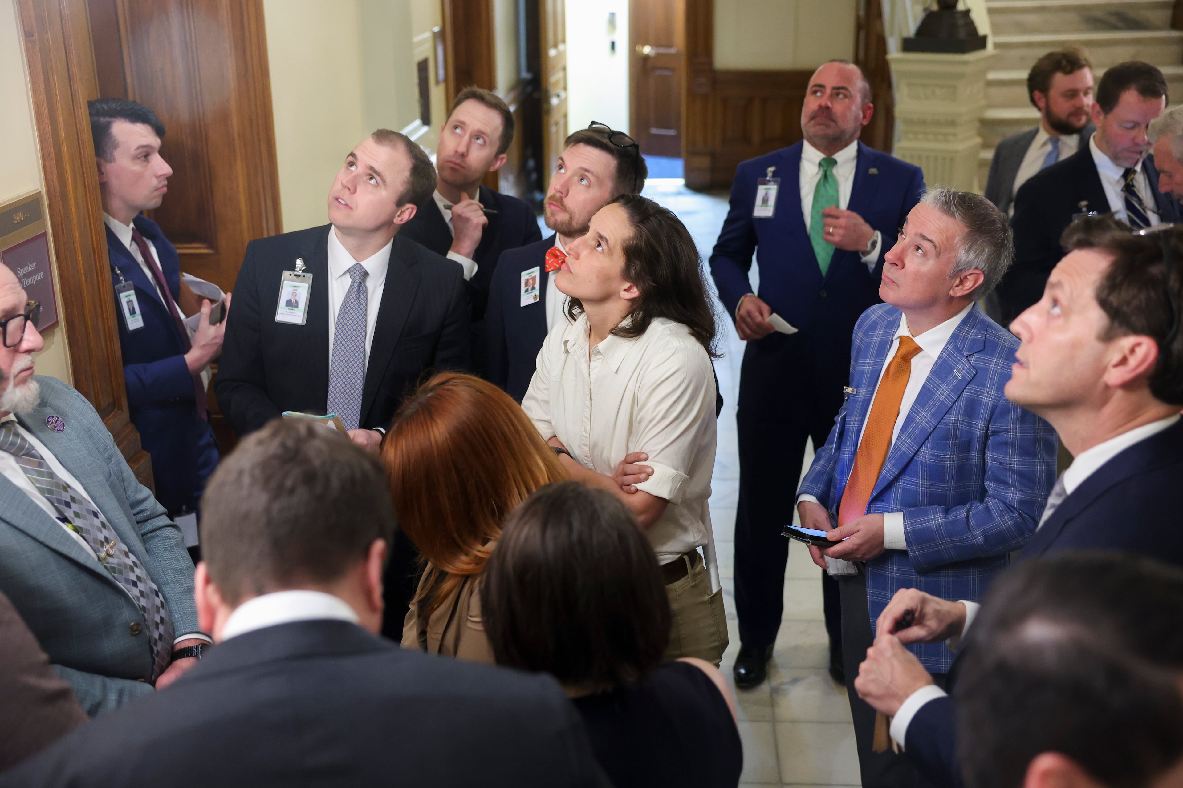 Lobbyists watch the House Rules Committee meeting on a television screen at the Capitol in Atlanta on Crossover Day, Friday, March 6, 2026. (Arvin Temkar/AJC)