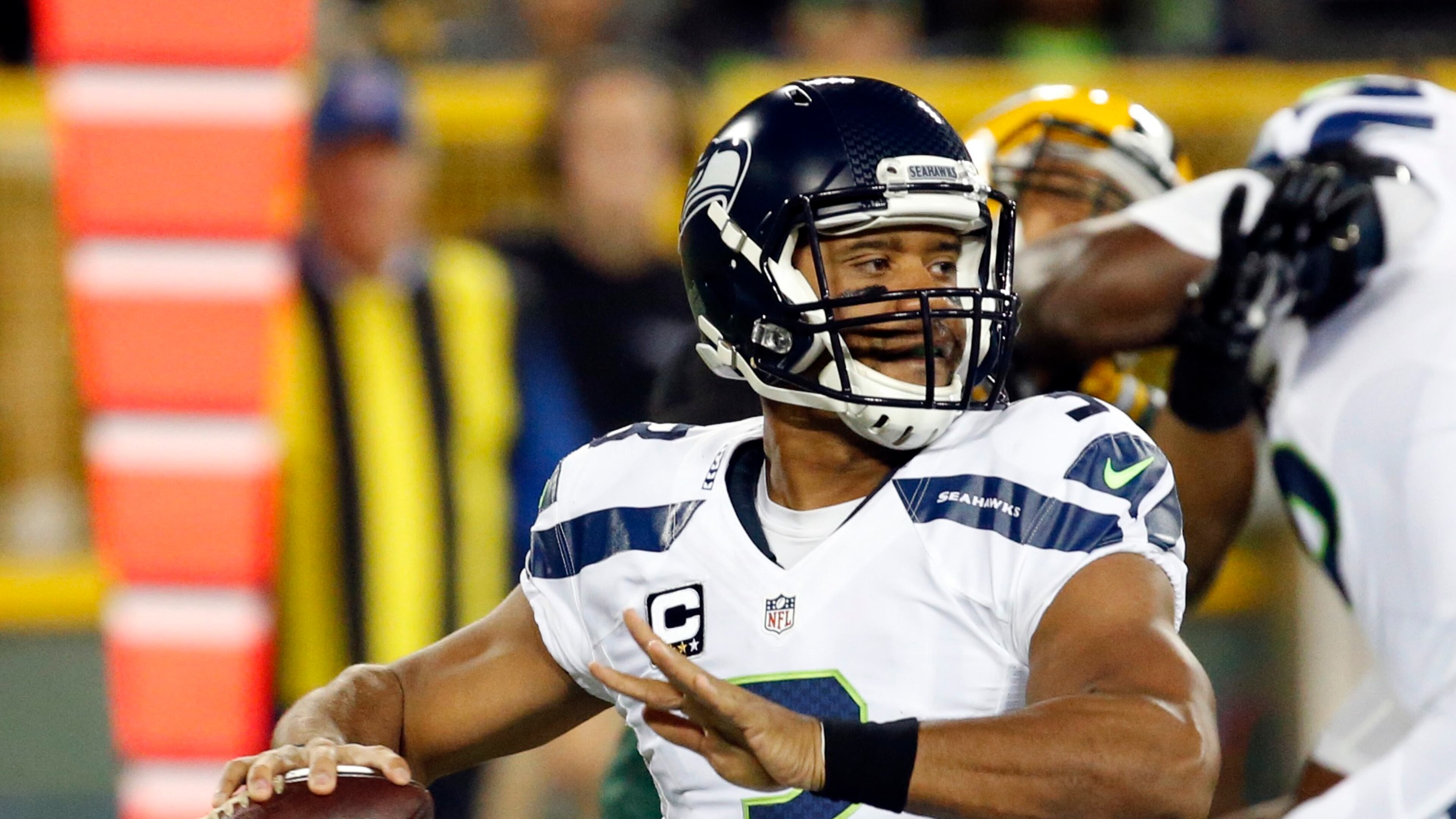 Seattle Seahawks quarterback Russell Wilson drops back during the first half of an NFL football game against the Green Bay Packers Sunday, Sept. 20, 2015, in Green Bay, Wis. (AP Photo/Mike Roemer)