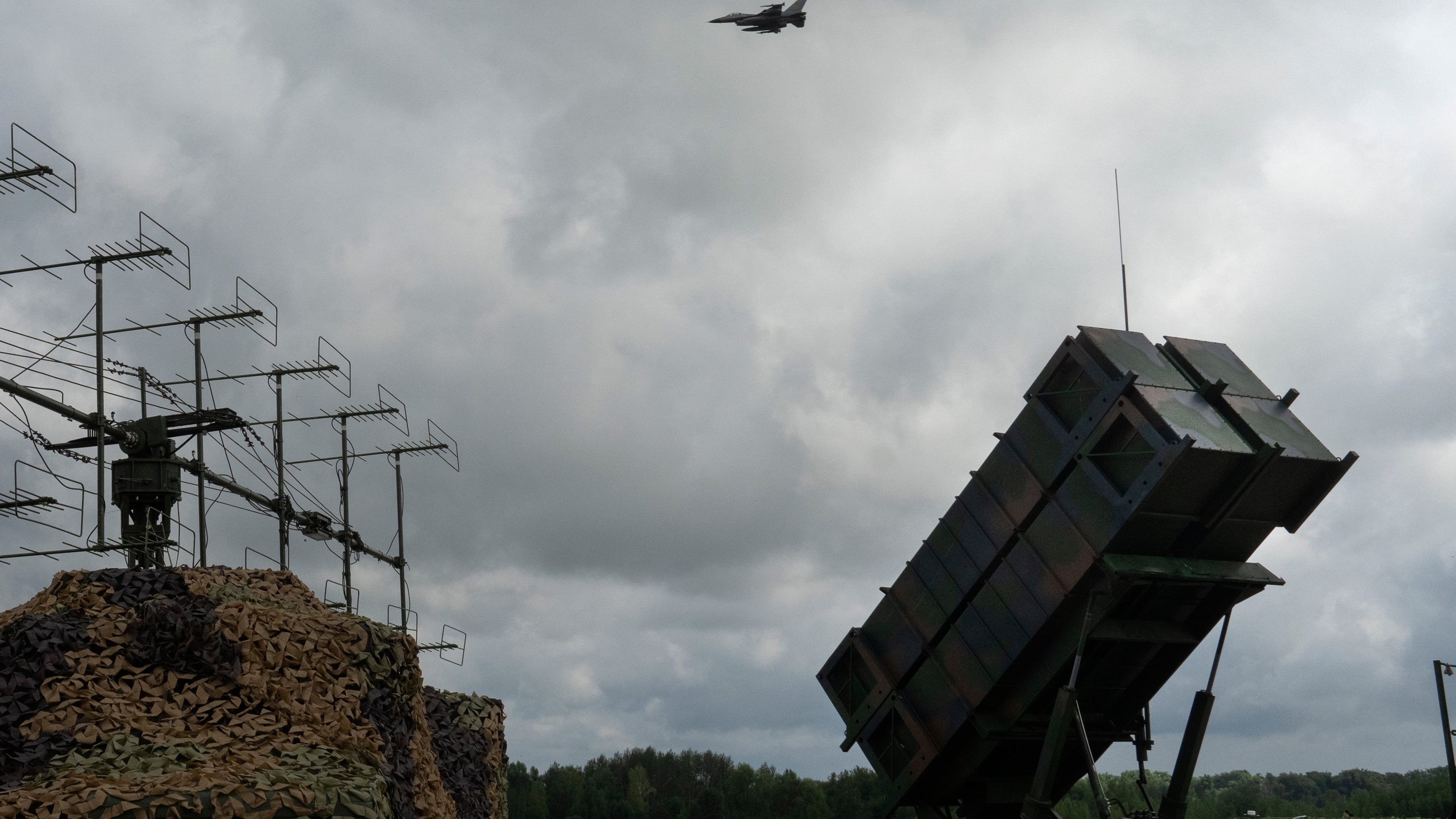 FILE - Ukrainian Air Force's F-16 fighter jets fly over a Patriot Air and Missile Defense System in an undisclosed location in Ukraine, on Aug. 4, 2024. (AP Photo/Efrem Lukatsky, File)