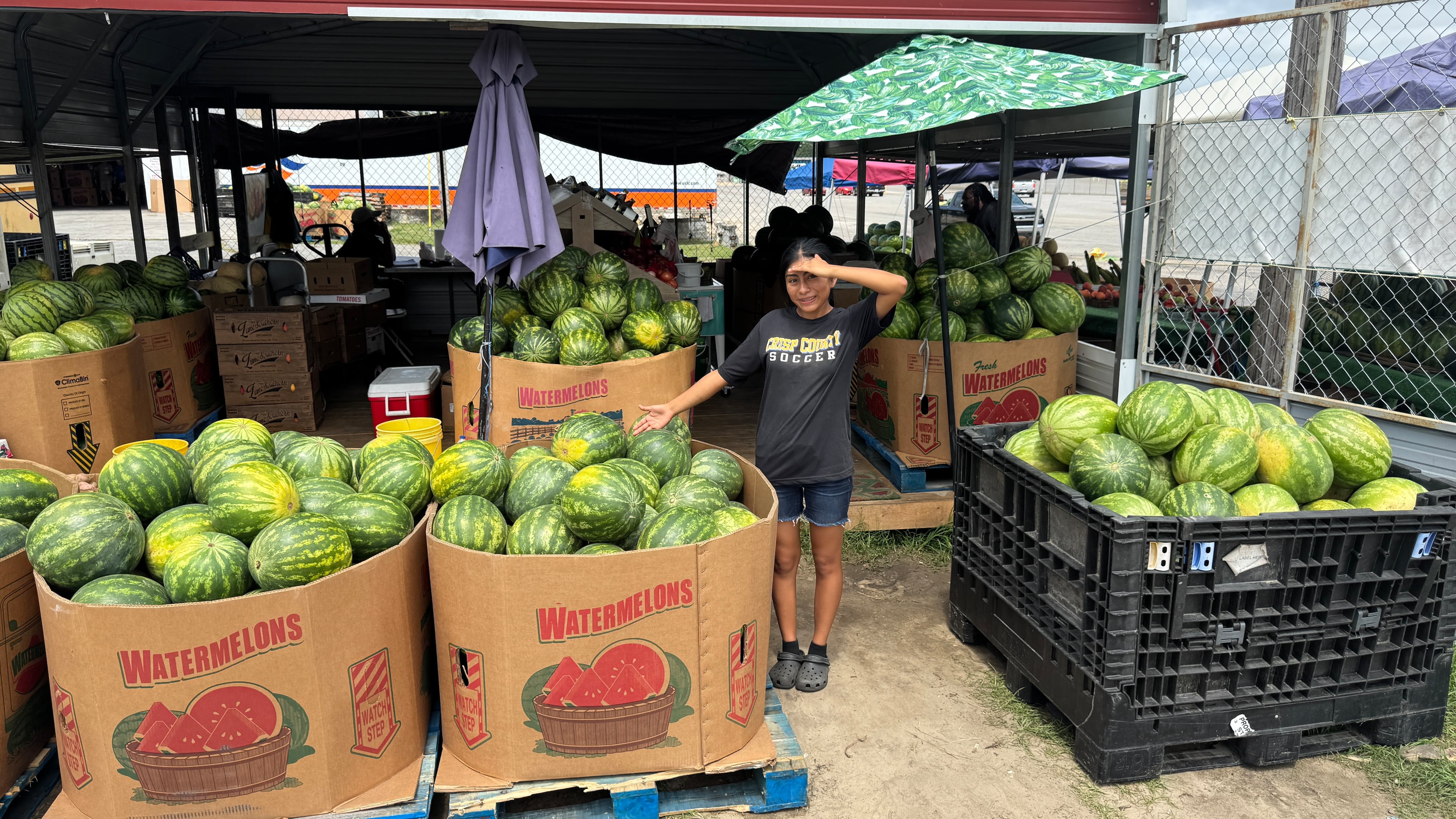 Ana Gomez works as a watermelon seller at the Melon Shack, just outside the main gate at the Cordele State Farmers Market along U.S. 41 in Crisp County. She has an ear for ripe melons and says, “If it sounds hollow-ish or like a basketball, it’s because it’s ready to eat." (Joe Kovac Jr./AJC)
