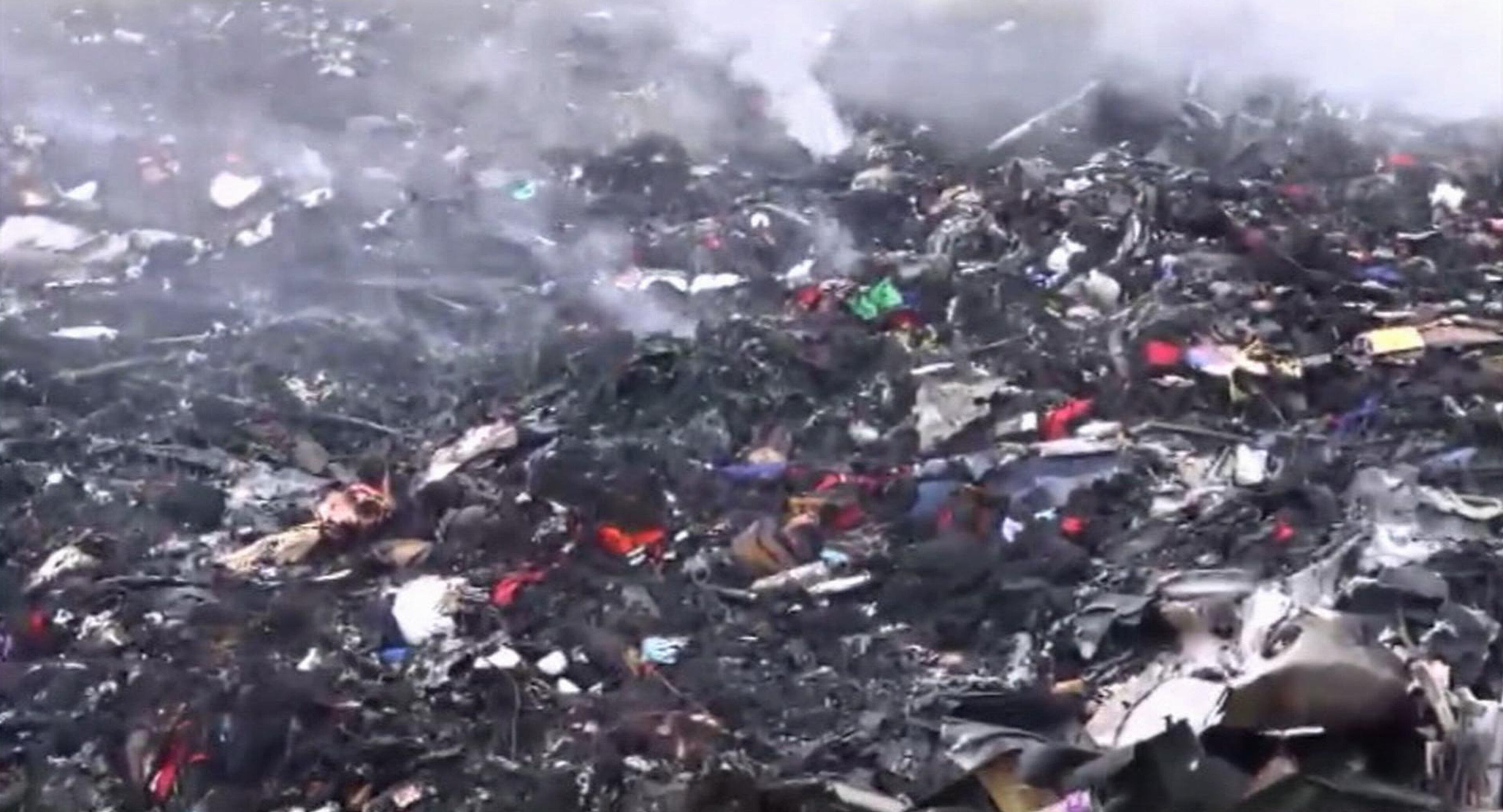 In this image taken from video, Thursday July 17, 2014, showing debris at the crash site after a passenger plane carrying 295 people was shot down Thursday as it flew over Ukraine, near the village of Hrabove, in eastern Ukraine. Malaysia Airlines tweeted that it lost contact with one of its flights as it was traveling from Amsterdam to Kuala Lumpur over Ukrainian airspace. (AP Photo / Channel 1)