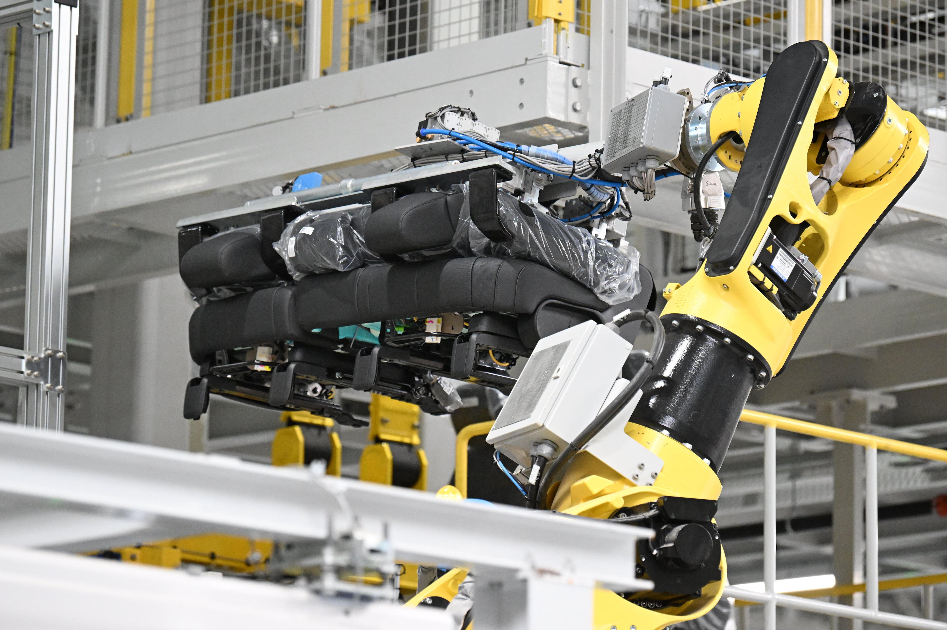 Oh, the robotic arm can install a car seat? Bet it can't pull off fourth finger vibrato on a violin. (Hyosub Shin/AJC)