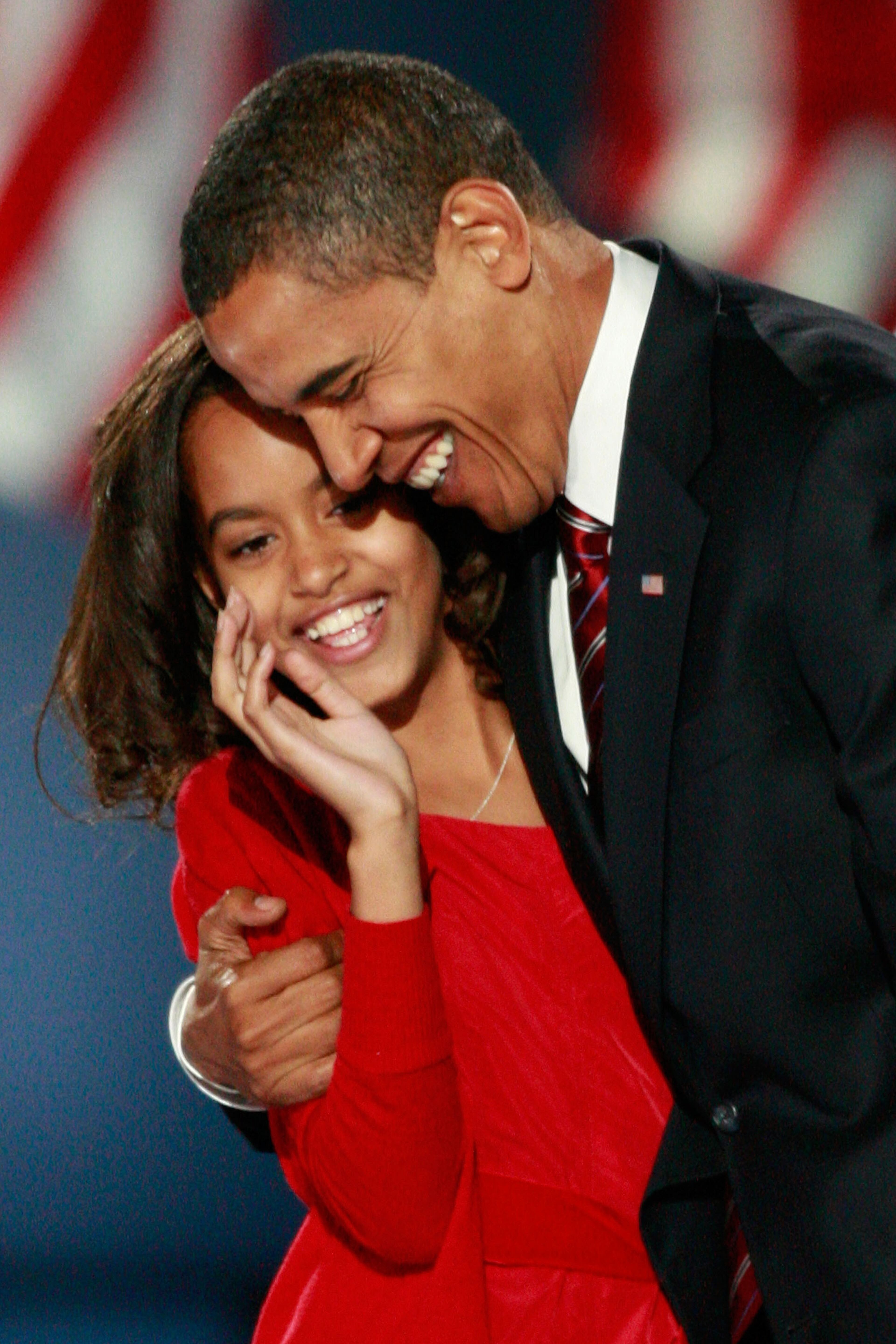 U.S. President elect Barack Obama embraces his daughter Malia after Obama gave his victory speech during an election night gathering in Grant Park on November 4, 2008 in Chicago, Illinois. Obama defeated Republican nominee Sen. John McCain (R-AZ) by a wide margin in the election to become the first African-American U.S. President elect. (Photo by Scott Olson/Getty Images)