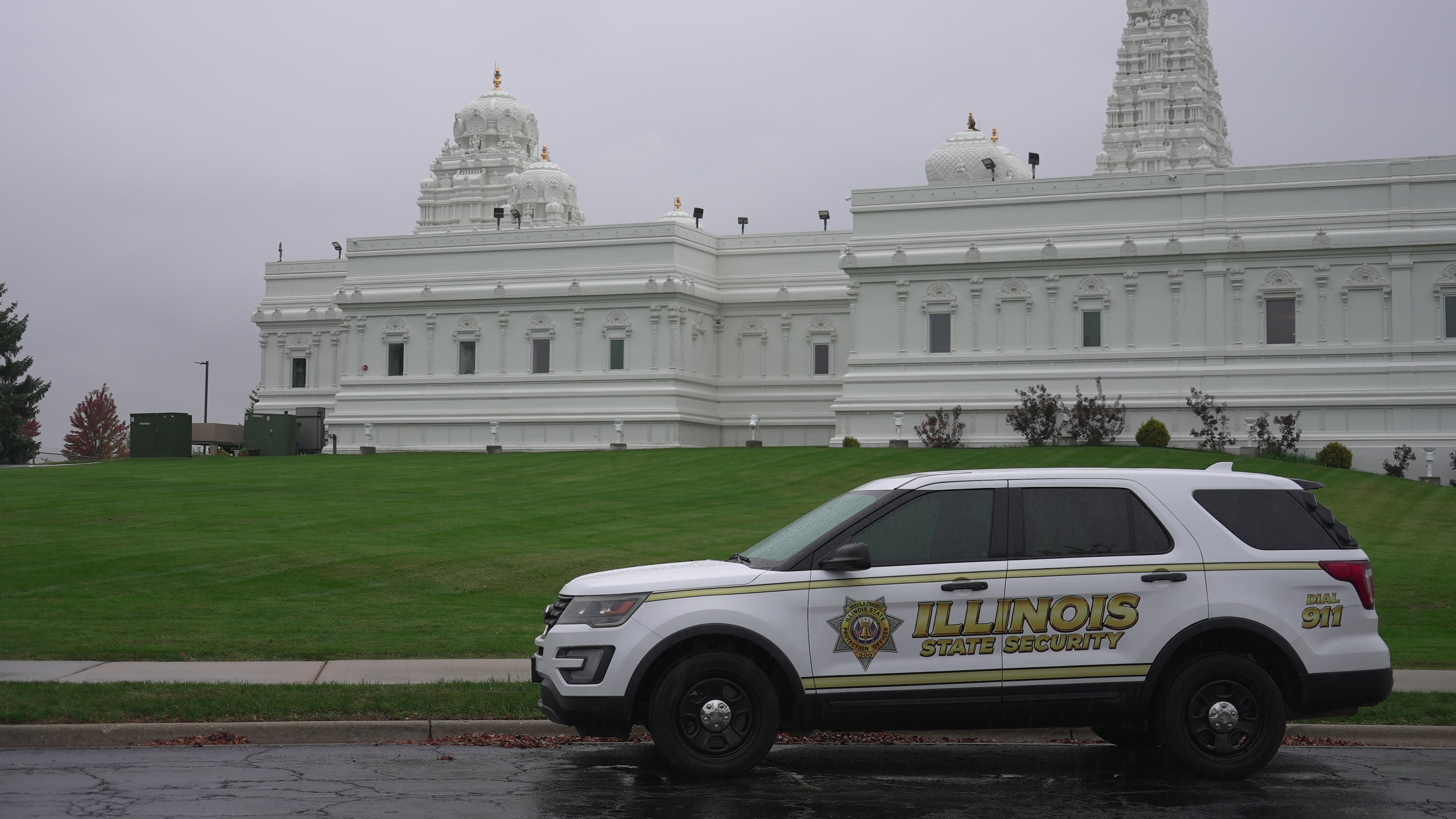 A security vehicle is parked outside of Sri Venkateswara Swami (Balaji) Temple in Aurora, Ill., Thursday, Oct. 15, 2026. (AP Photo/Laura Bargfeld)