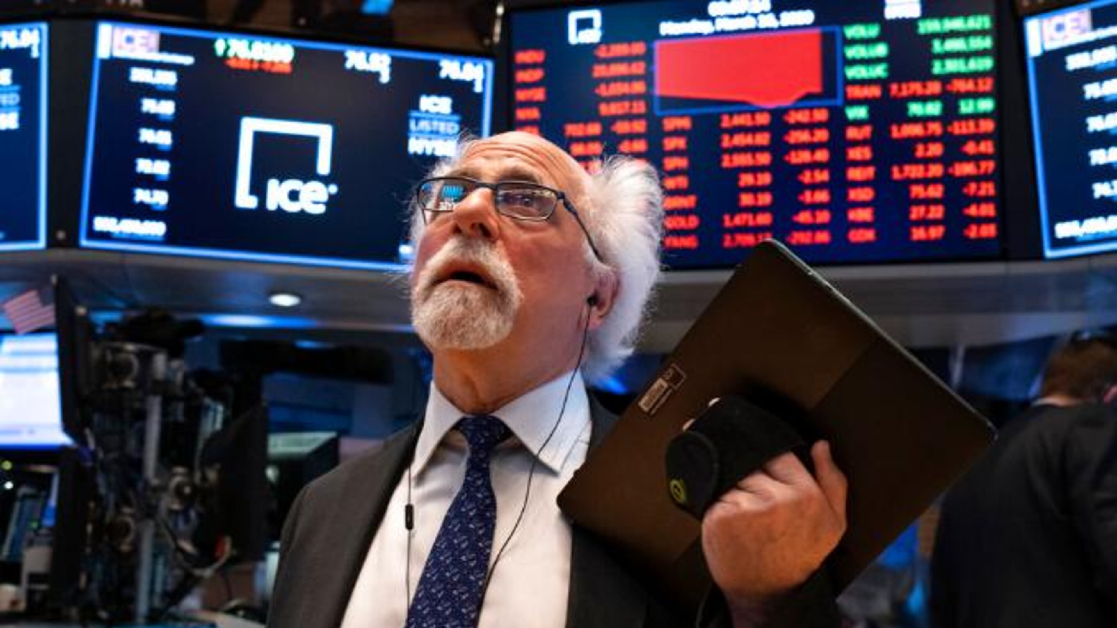 FILE - In this March 16, 2020 file photo, trader Peter Tuchman works on the floor of the New York Stock Exchange. He has tested positive for coronavirus. (AP Photo/Craig Ruttle, File)