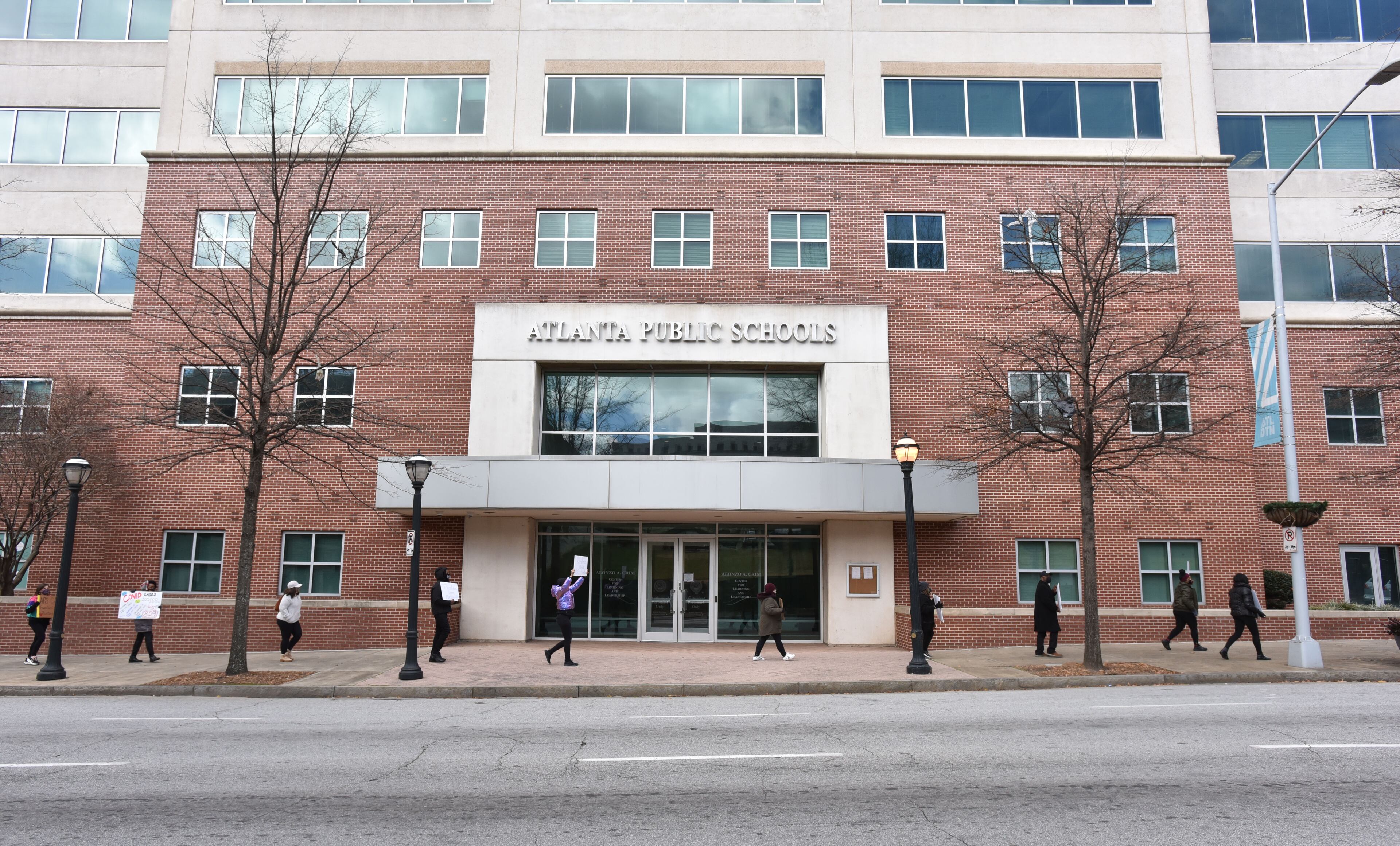 APS teachers and supporters holding signs march around the Atlanta Public Schools headquarters to push for APS to delay reopening school buildings on Saturday, January 16, 2021. (Photo: Hyosub Shin / Hyosub.Shin@ajc.com)