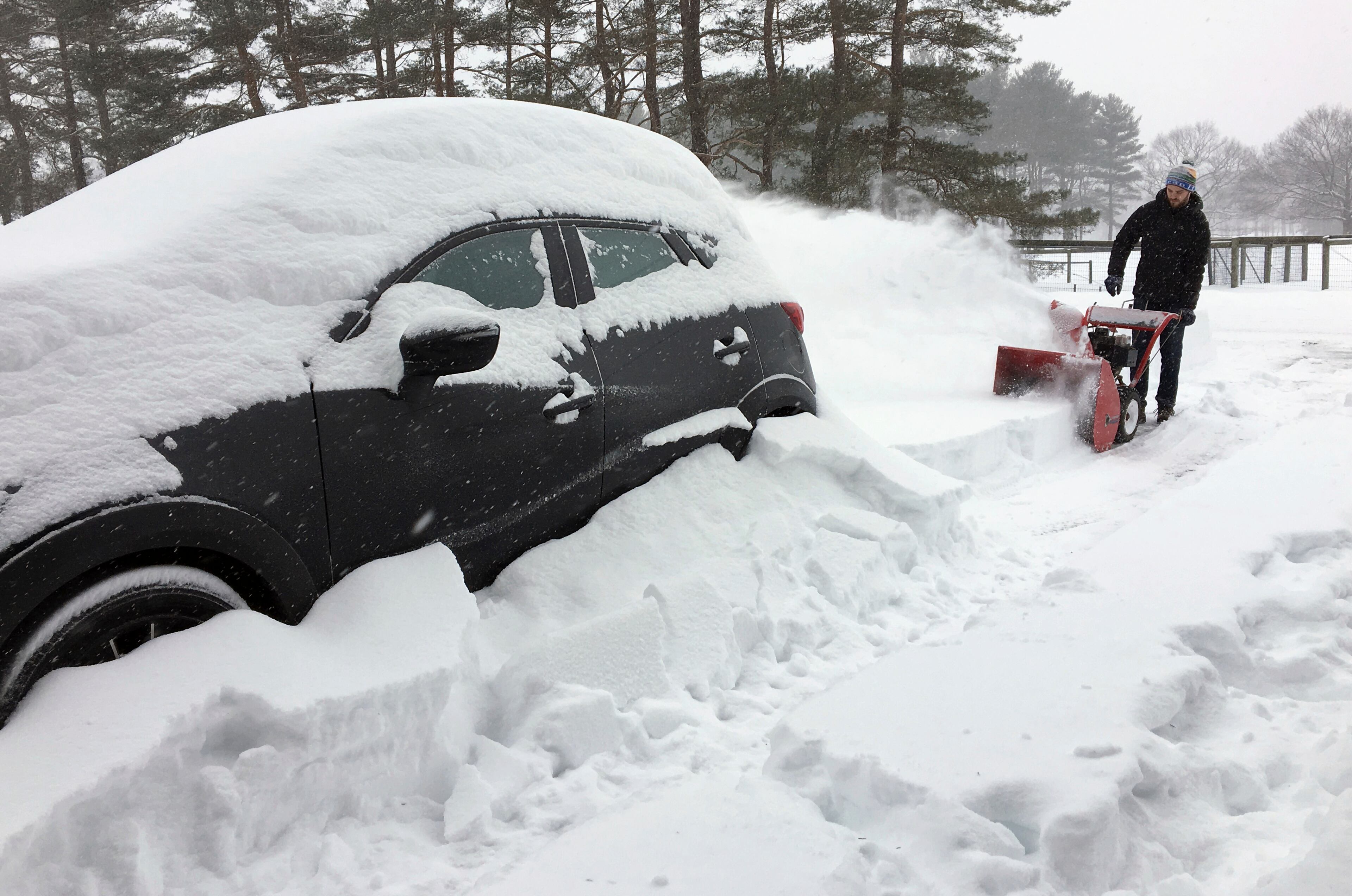Ben Jennings snowblows his driveway on Sunday, Jan. 20, in Glenville, N.Y., where 16 inches of snow fell from Saturday evening through noon Sunday.