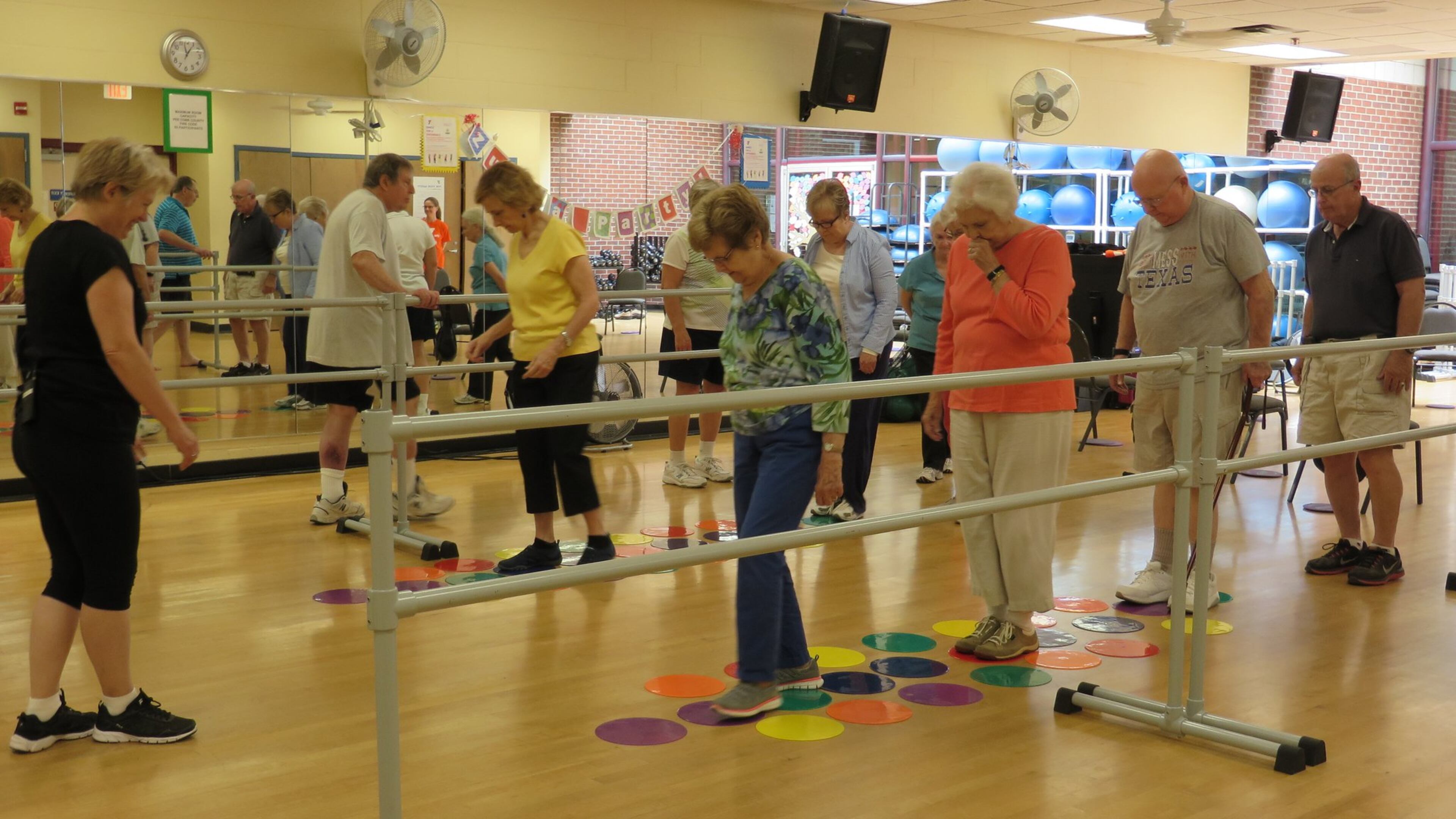 Fitness instructor Katy Pate (left) leads a Parkinson’s support class at the McCleskey-East Cobb Family YMCA. Free six-month YMCA family memberships are available for those with Parkinson’s thanks to a grant from the National Parkinson Foundation. Contributed by Laura Berrios