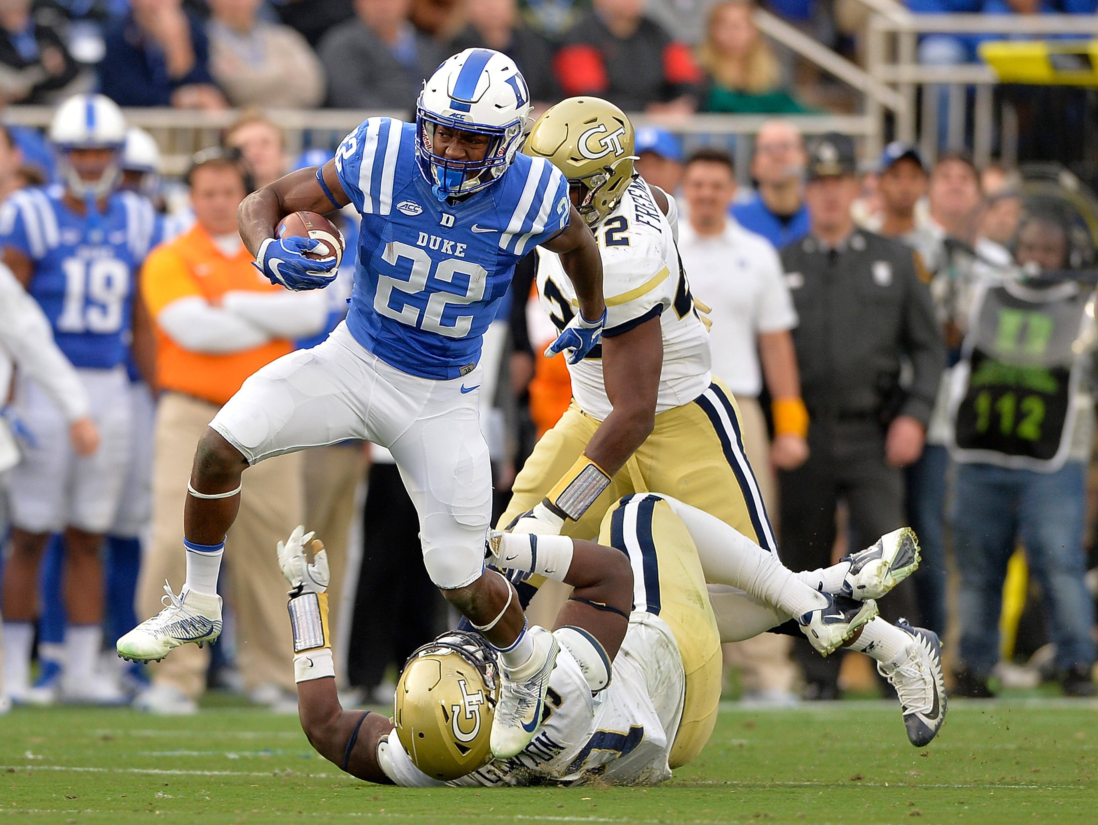 DURHAM, NC - NOVEMBER 18: Brittain Brown #22 of the Duke Blue Devils breaks away from Brentavious Glanton #97 of the Georgia Tech Yellow Jackets for a long gain during their game at Wallace Wade Stadium on November 18, 2017 in Durham, North Carolina. (Photo by Grant Halverson/Getty Images)