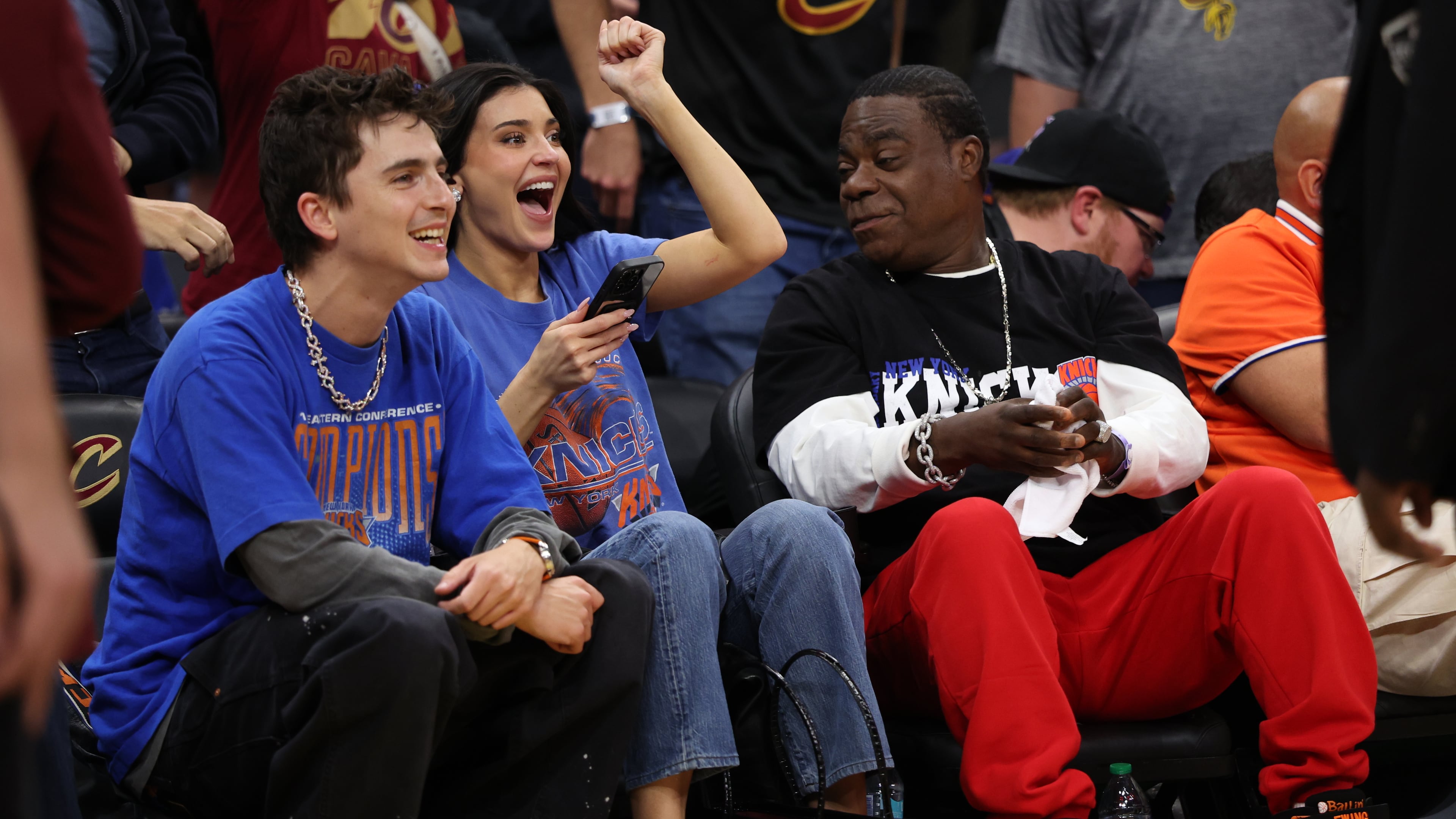 Timothée Chalamet, left, Kylie Jenner, center, and Tracy Morgan watch the second half of Game 4 in the Eastern Conference finals NBA basketball playoffs series between the New York Knicks and the Cleveland Cavaliers in Cleveland, Monday, May 25, 2026. (AP Photo/Tim Phillis)
