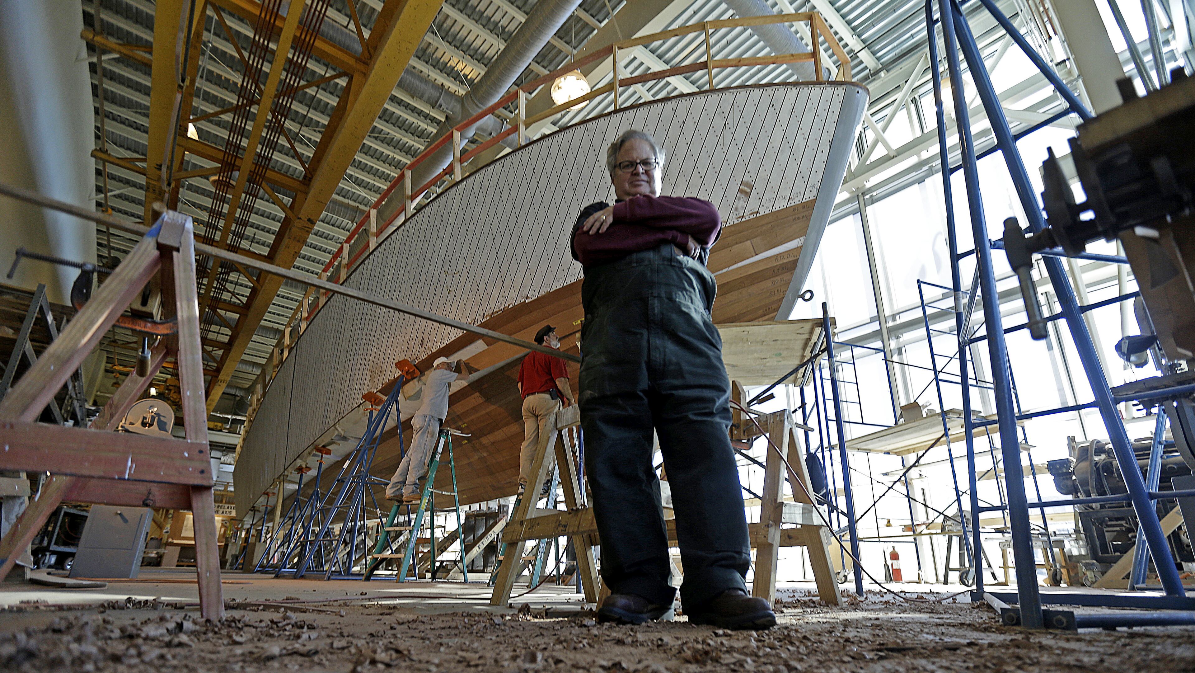 FILE - In this Dec. 18, 2013 file photo, Tom Czekanski, senior curator and restoration manager at the National World War II Museum, stands in front of one of the surviving World War II-era PT boats as it undergoes restoration in New Orleans. The PT-305, a U.S. Navy patrol torpedo boat that sank three vessels and saw action in Europe, is back in New Orleans where it was built and tested - what historians describe as the nation's only fully restored ship of that type that saw direct combat in World War II. (AP Photo/Gerald Herbert, File)