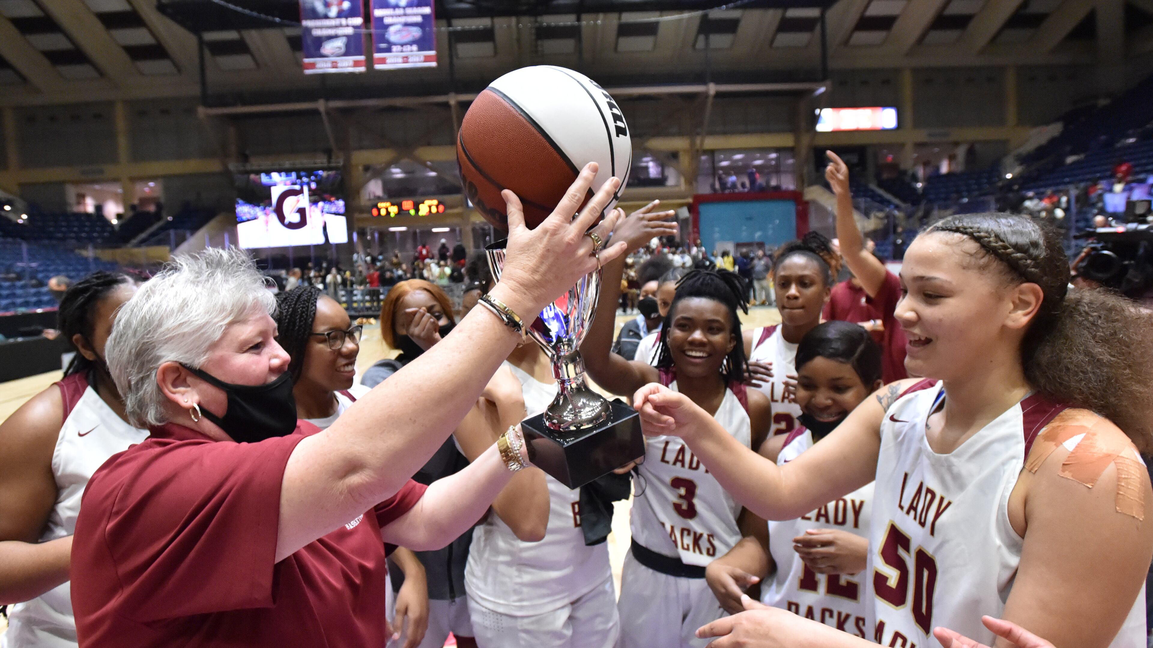 March 12, 2021 Macon - Cross Creek's head coach Kim Schlein and players celebrate their victory over Greater Atlanta Christian during the 2021 GHSA State Basketball Class AAA Girls Championship game at the Macon Centreplex in Macon on Friday, March 12, 2021 Cross Creek won 56-44 over Greater Atlanta Christian. (Hyosub Shin / Hyosub.Shin@ajc.com)