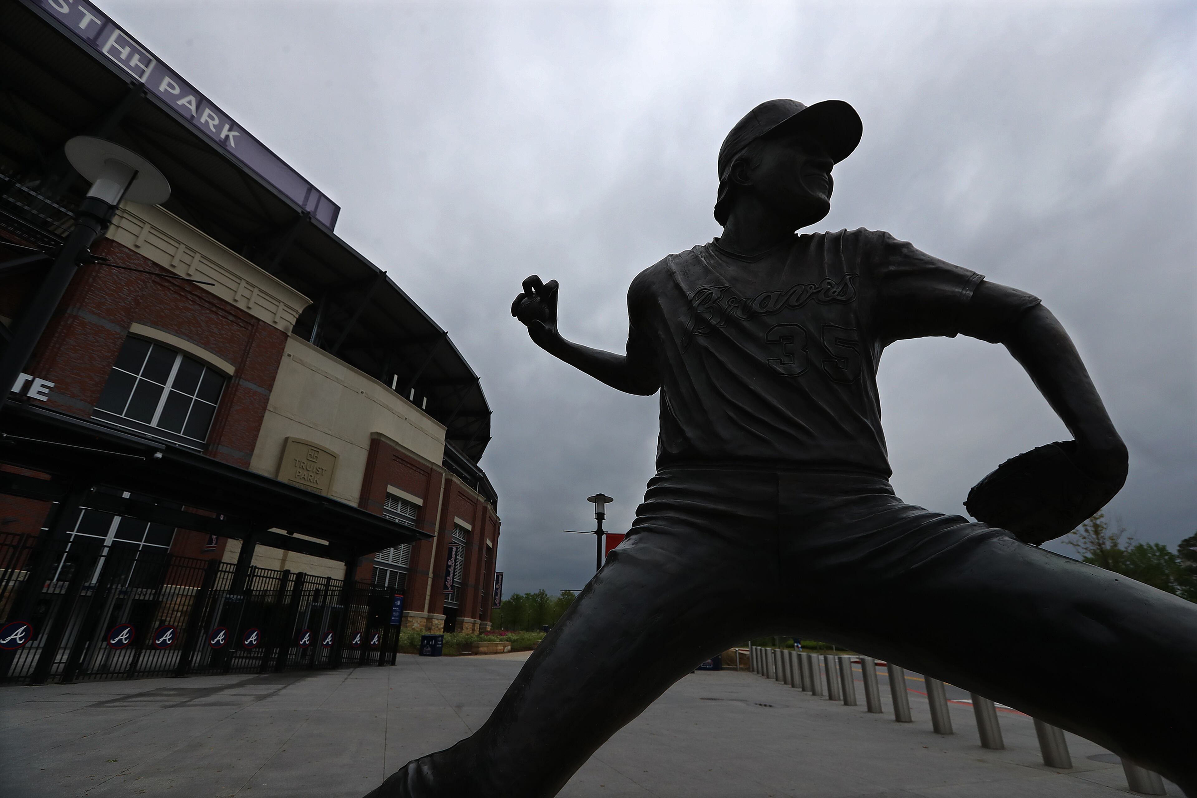 A statue of Atlanta Braves pitcher Phil Niekro, the winningest knuckleball pitcher in major league history with 318 wins, sits outside newly renamed Truist Park on Tuesday, March 31, 2020, in Atlanta. The Atlanta Braves were supposed to host their home opener Friday, but the season's start was postponed by Major League Baseball because of the coronavirus pandemic. No one know when, or even if, the 2020 season will start, or how long it might last. Curtis Compton ccompton@ajc.com