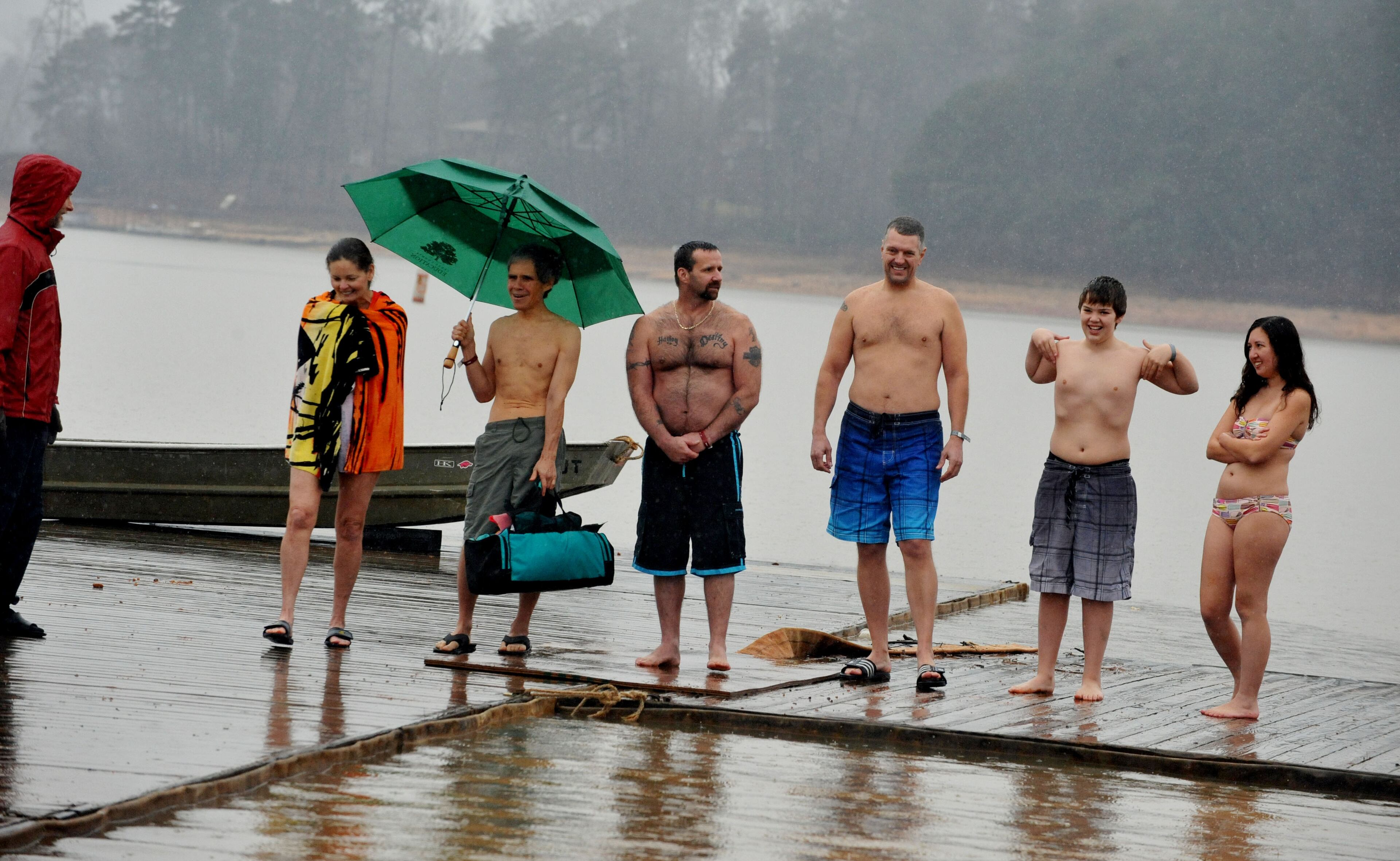 JANUARY 1, 2013 GAINESVILLE Participants braved 48 degree water for the 16th annual Polar Bear Swim at the Lanier Canoe & Kayak Club Tuesday Jan. 1, 2013. The 16th annual Polar Bear Swim is a New Years tradition for the club. About 100 people took a polar plunge, despite rain and temperatures in the upper 40's. The event is a fundraiser for LCKC, with proceeds going to benefit the club's youth programs and other activities. Participants warmed up in a hot tub, got an event T-shirt, a bowl of chili and a drink to warm their bones. KENT D. JOHNSON / KDJOHNSON@AJC.COM