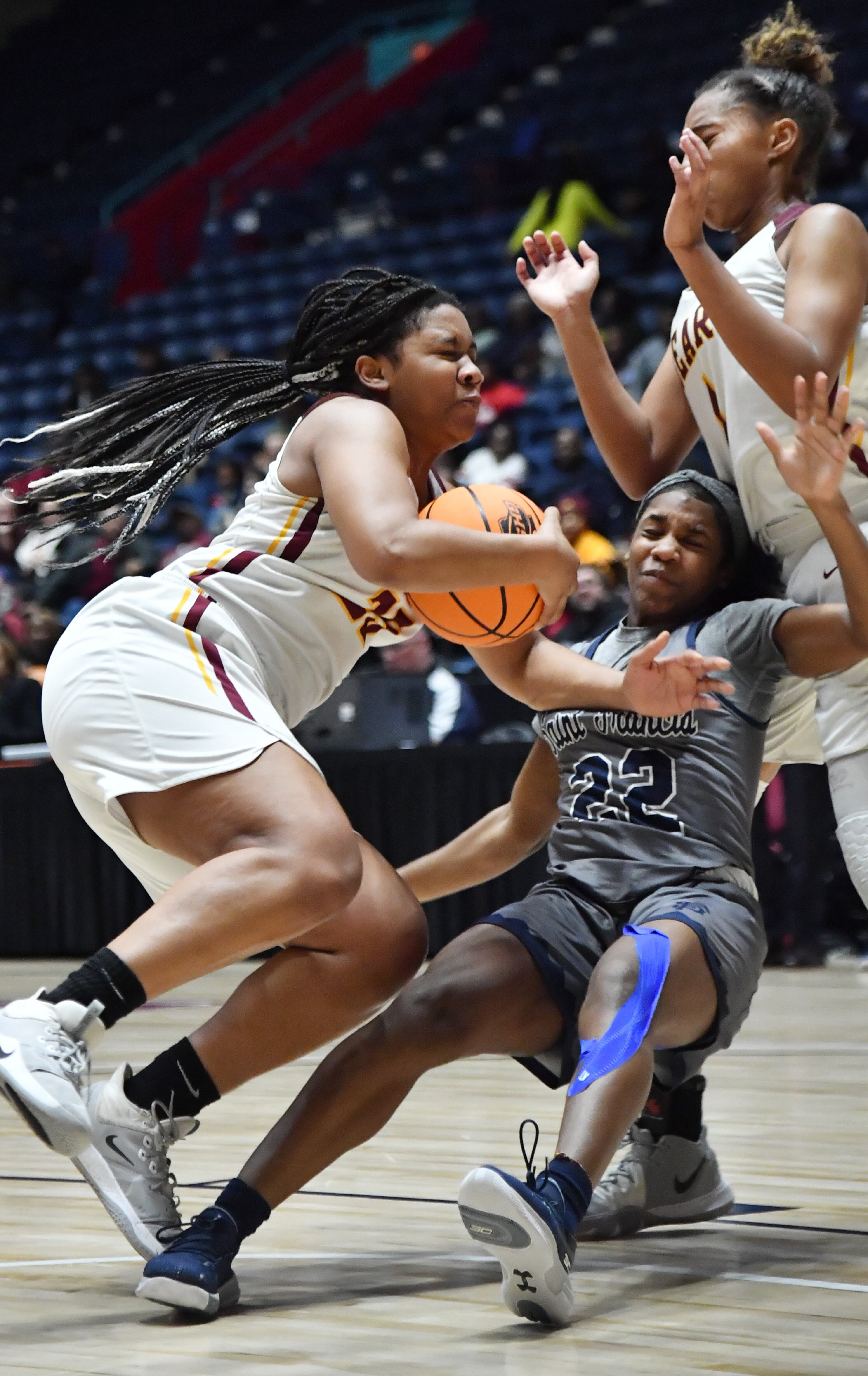 Holy Innocents' Jada Farrell (left) and St. Francis' Mia Moore (22) fall as they fight for a loose ball. (Hyosub Shin / Hyosub.Shin@ajc.com)