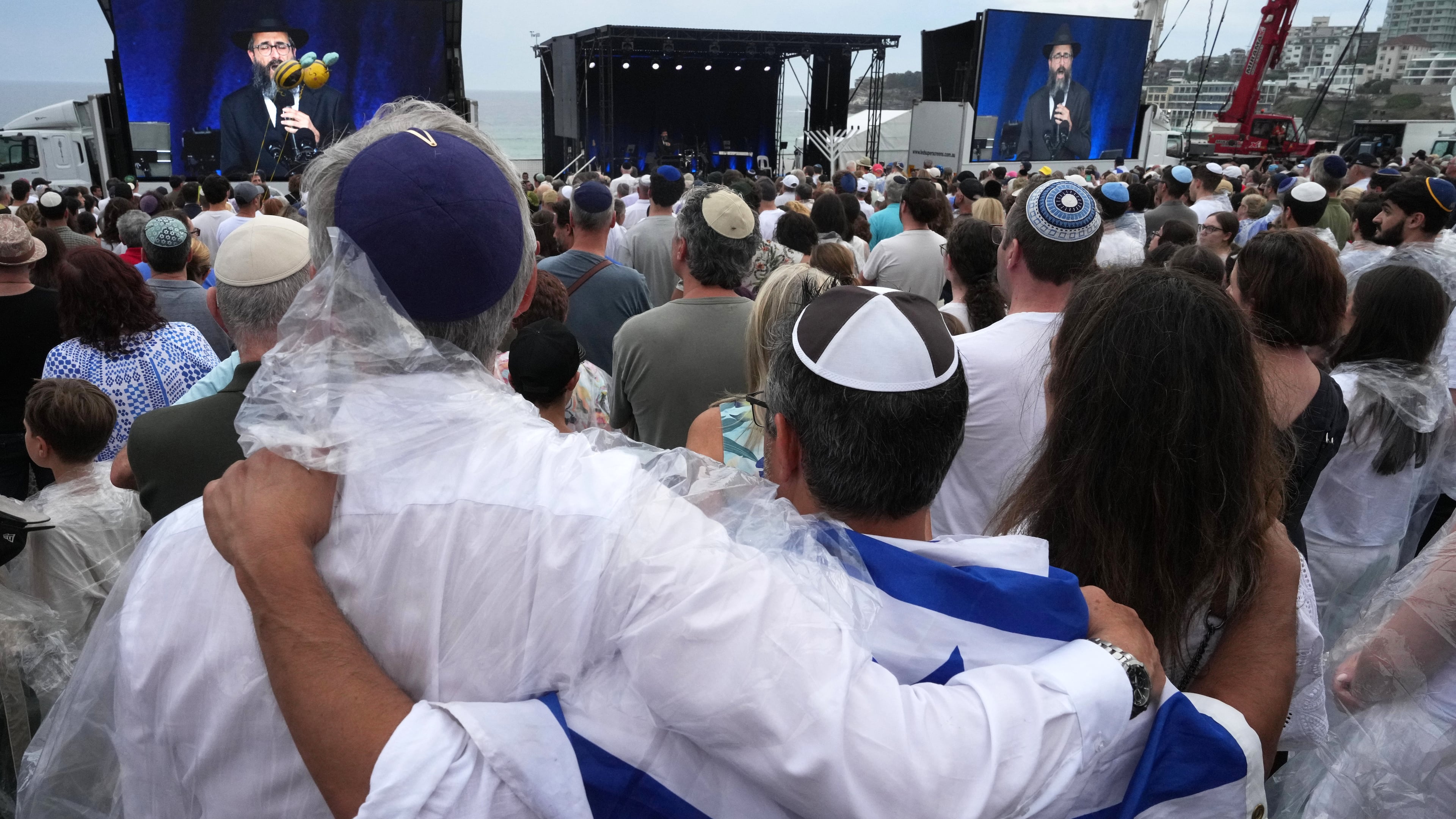 FILE - People attend a ceremony to mark the National Day of Reflection for victims and survivors, at Bondi Beach in Sydney, Sunday, Dec. 21, 2025, following the Bondi shooting on Dec. 14. (AP Photo/Mark Baker,File)