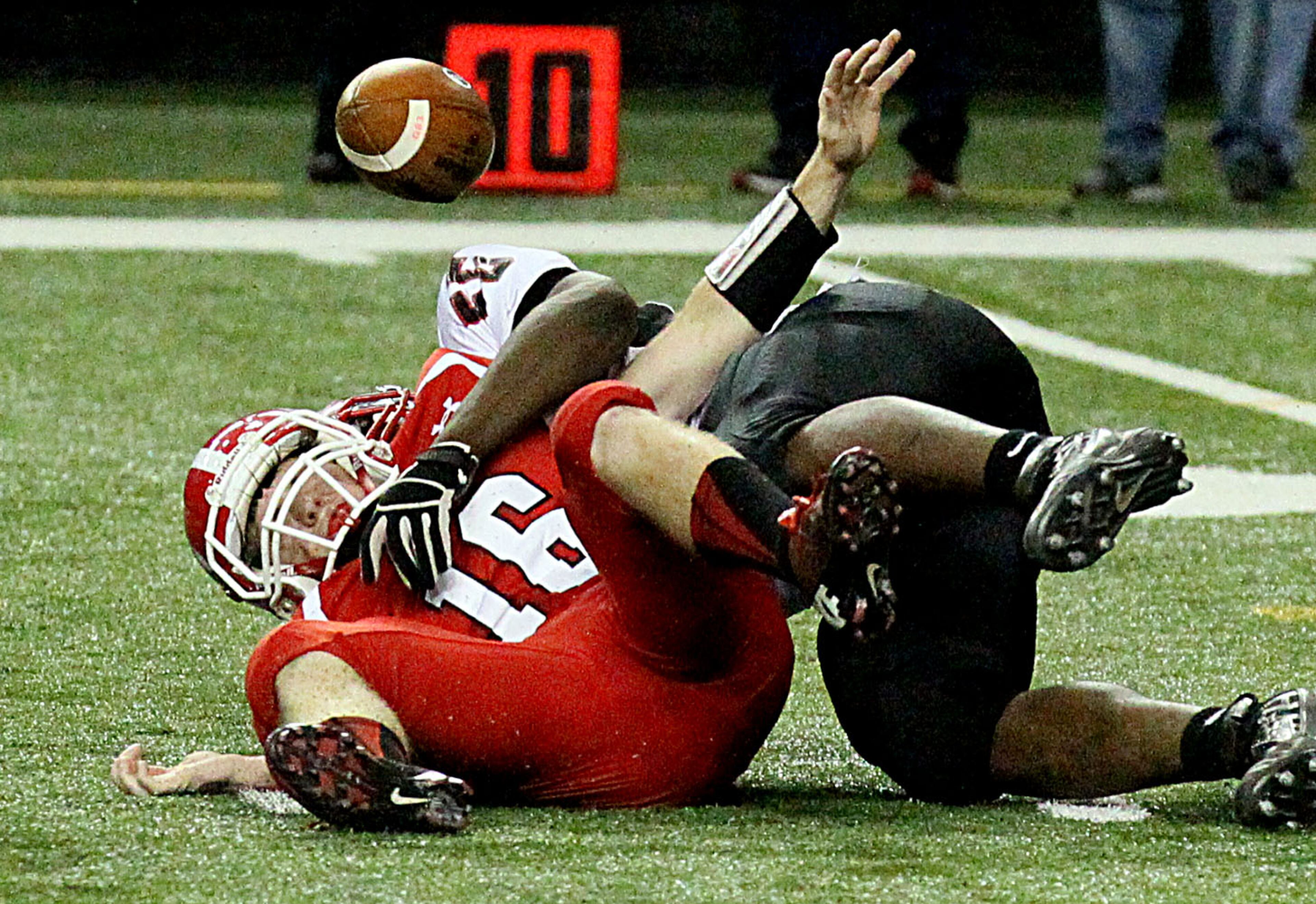 Marion County's (Buena Vista, GA) quarterback #16 Justin Eckert is sacked by Charlton County's (Folkston) #55 Teon Burroughs causing a fumble that Marion County recovered during their GHSA Class A-Public Football Championship game at the Georgia Dome in Atlanta on Saturday, December 14, 2013.