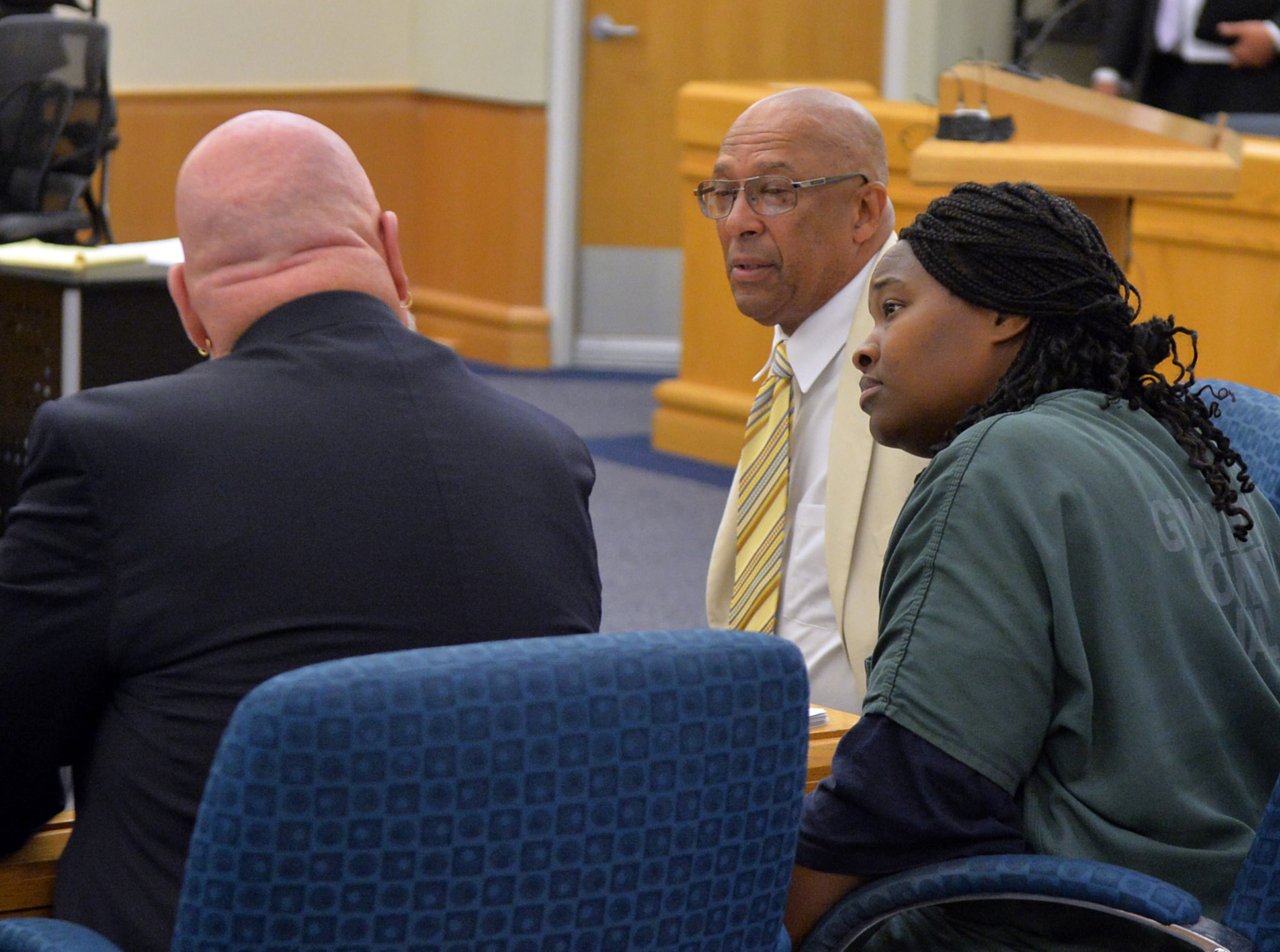 Therian Wimbush talks with her defense attorneys Jeff Sliz (left) and Dwight Thomas (right) after being denied bond during a hearing before Gwinnett County Superior Court Judge Karen Beyers Tuesday, August 5, 2014. The former Georgia Tech football star and his wife were denied bond. They are accused of locking their 13 year old son in the basement for months. KENT D. JOHNSON/KDJOHNSON@AJC.COM