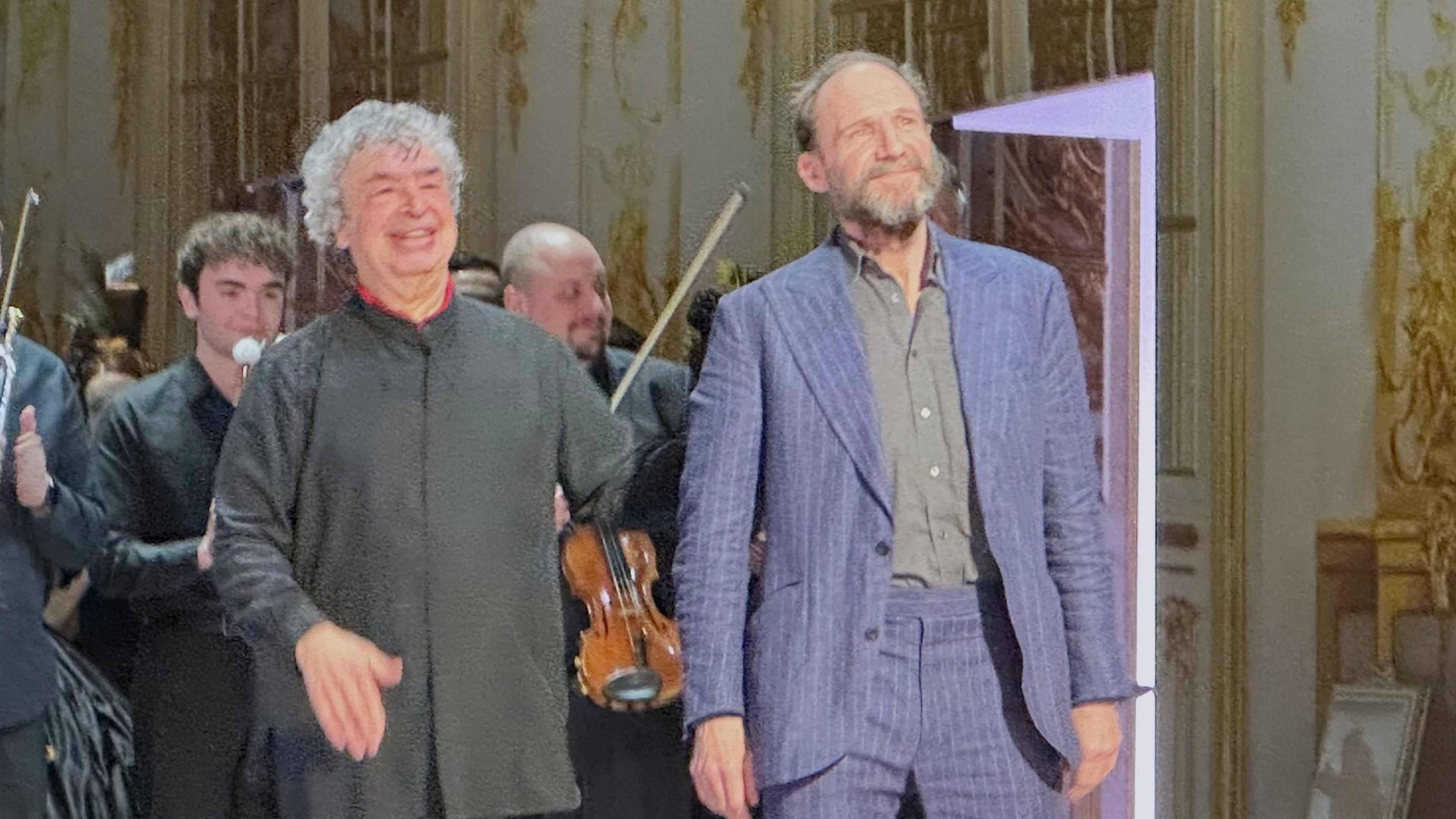 Ralph Fiennes, right, appears with conductor Semyon Bychkov during curtain calls after his opera directing debut of Tchaikovky’s “Eugene Onegin” at the Palais Garnier in Paris on Monday, Jan. 26, 2026. (AP Photo/Ron Blum)