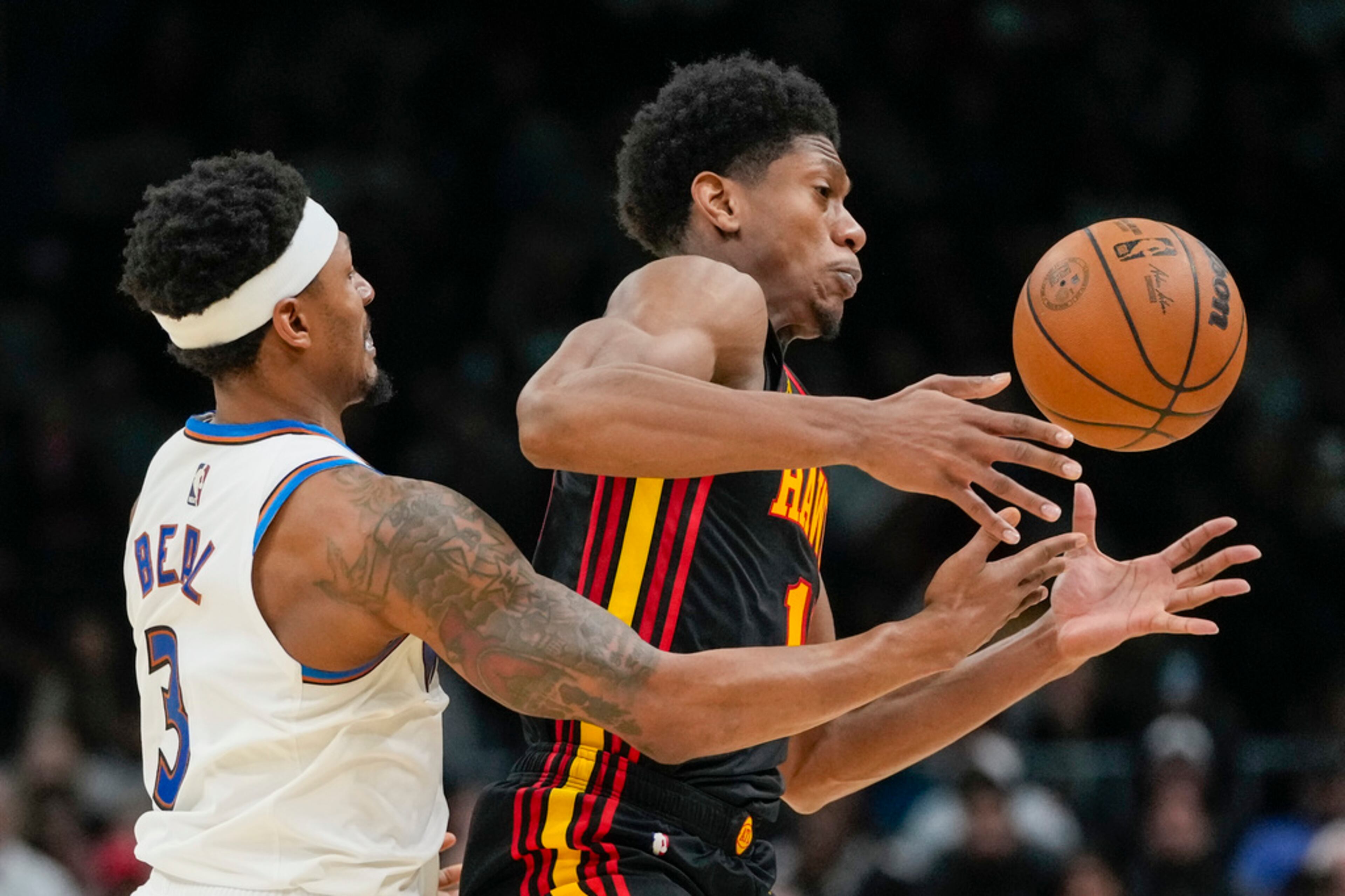 Washington Wizards guard Bradley Beal, left, knocks away a throw-in pass from Atlanta Hawks forward De'Andre Hunter during the second half of an NBA basketball game Friday, March 10, 2023, in Washington. The Hawks won 114-107. (AP Photo/Alex Brandon)