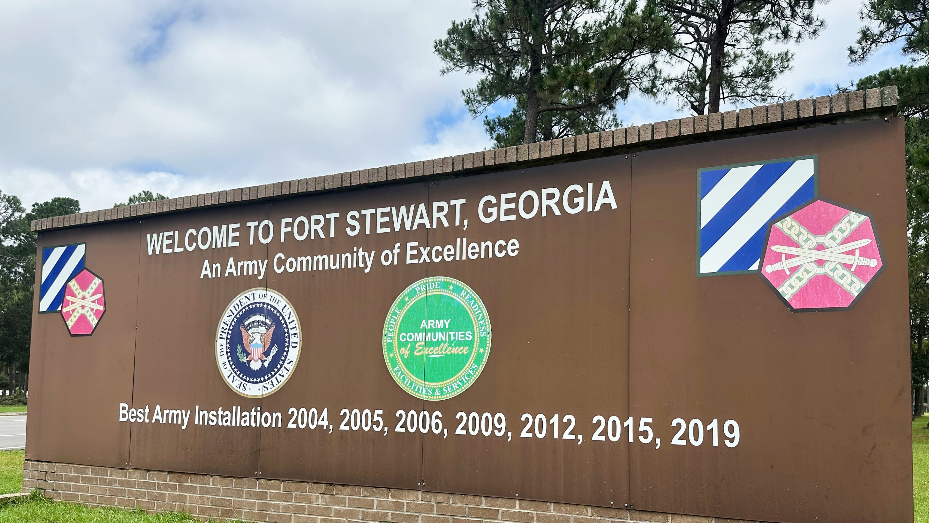 FILE - A sign stands outside the main gate of Fort Stewart, Ga., Aug. 6, 2025. (AP Photo/Russ Bynum, File)