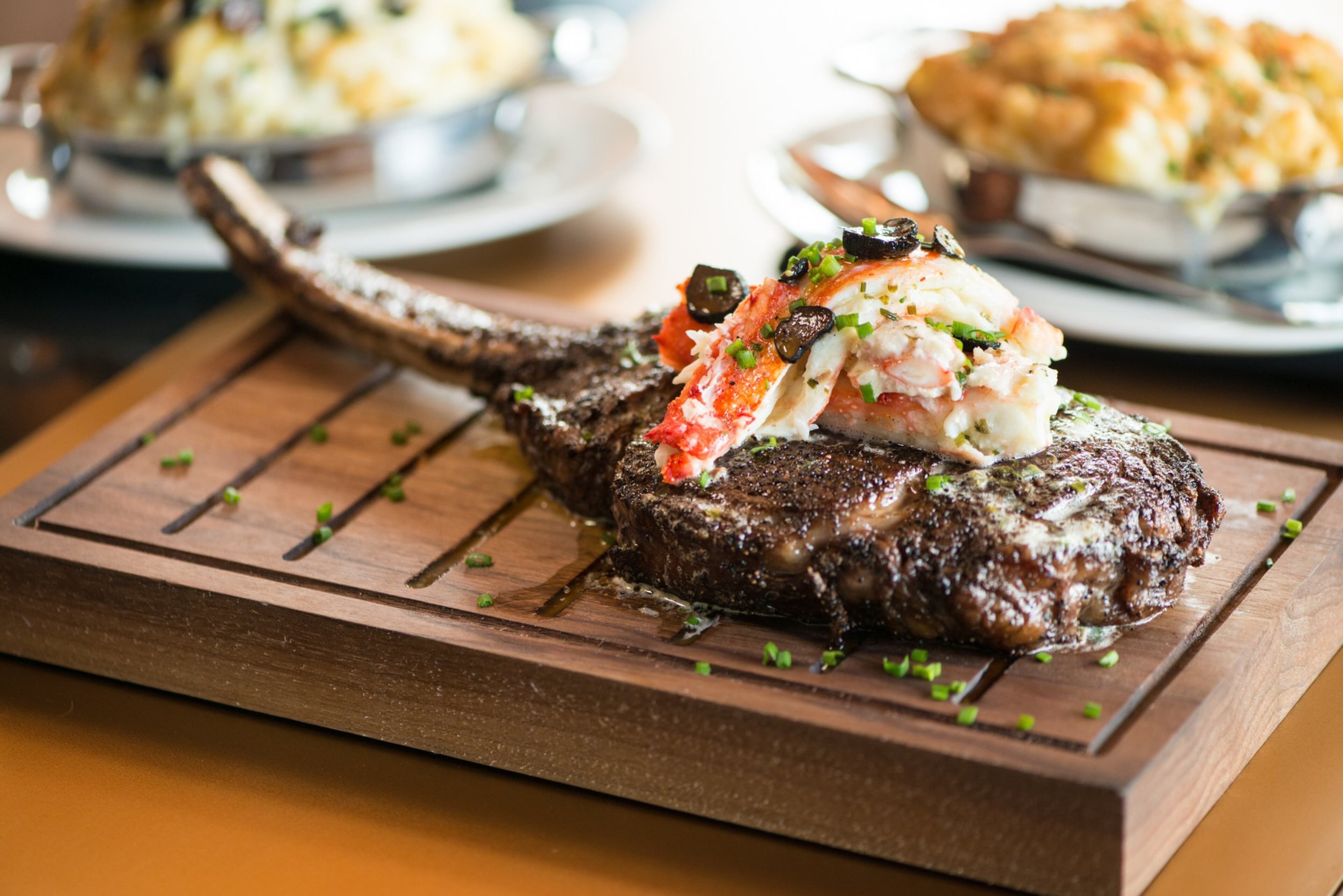 Del Frisco's Double Eagle Steakhouse Long- Bone Ribeye Wagyu Steak with crab. Photo credit- Mia Yakel.