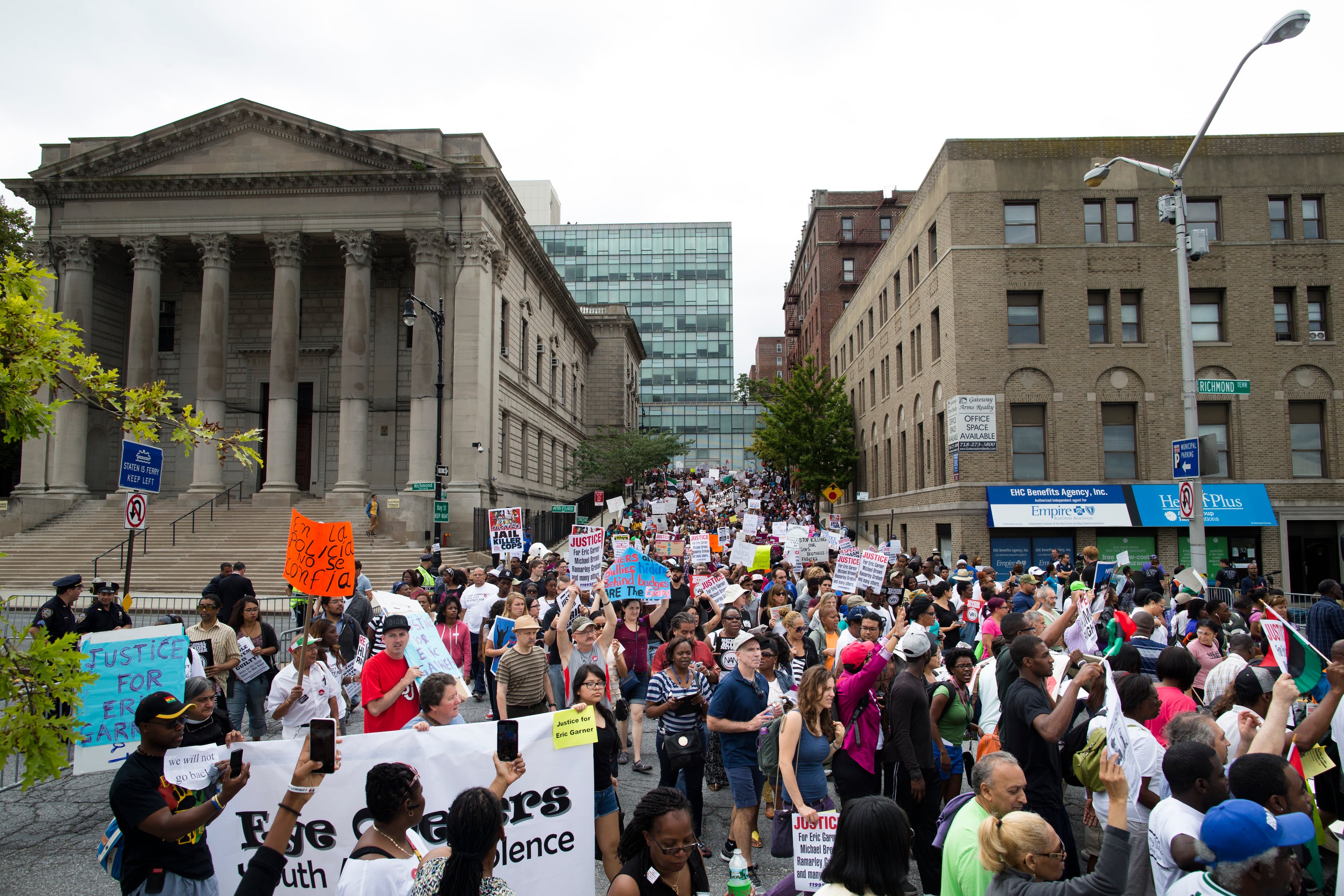 Demonstrators march to protest the death of 43-year-old Eric Garner, Saturday, Aug. 23, 2014, in the Staten Island borough of New York. The city medical examiner ruled that Eric Garner, 43, died as a result of a police chokehold during an attempted arrest. (AP Photo/John Minchillo)