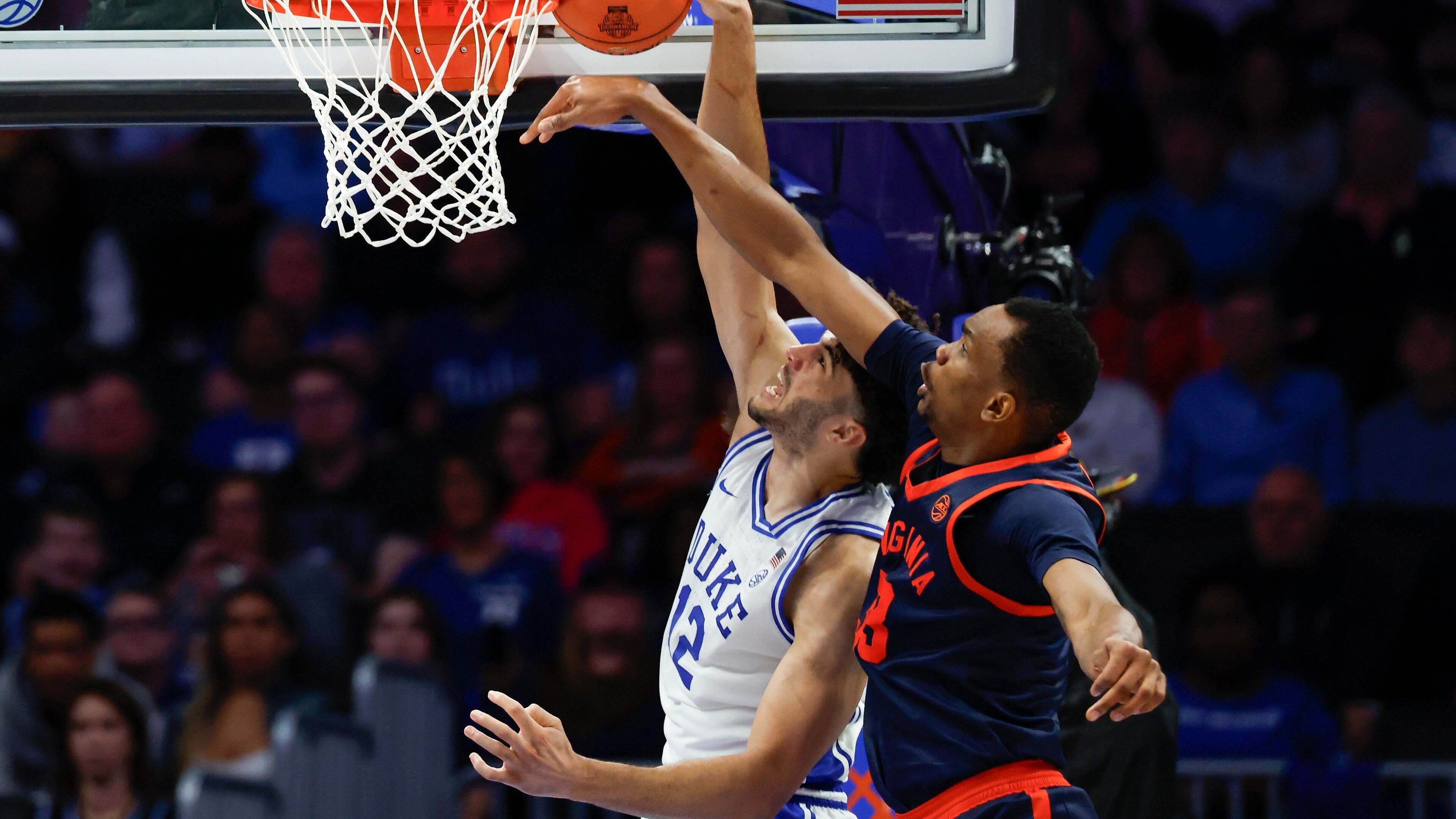 Virginia center Ugonna Onyenso, right, alters shot by Duke forward Cameron Boozer during the second half of an NCAA college basketball game in the championship of the Atlantic Coast Conference tournament in Charlotte, N.C., Saturday, March 14, 2026. (AP Photo/Nell Redmond)