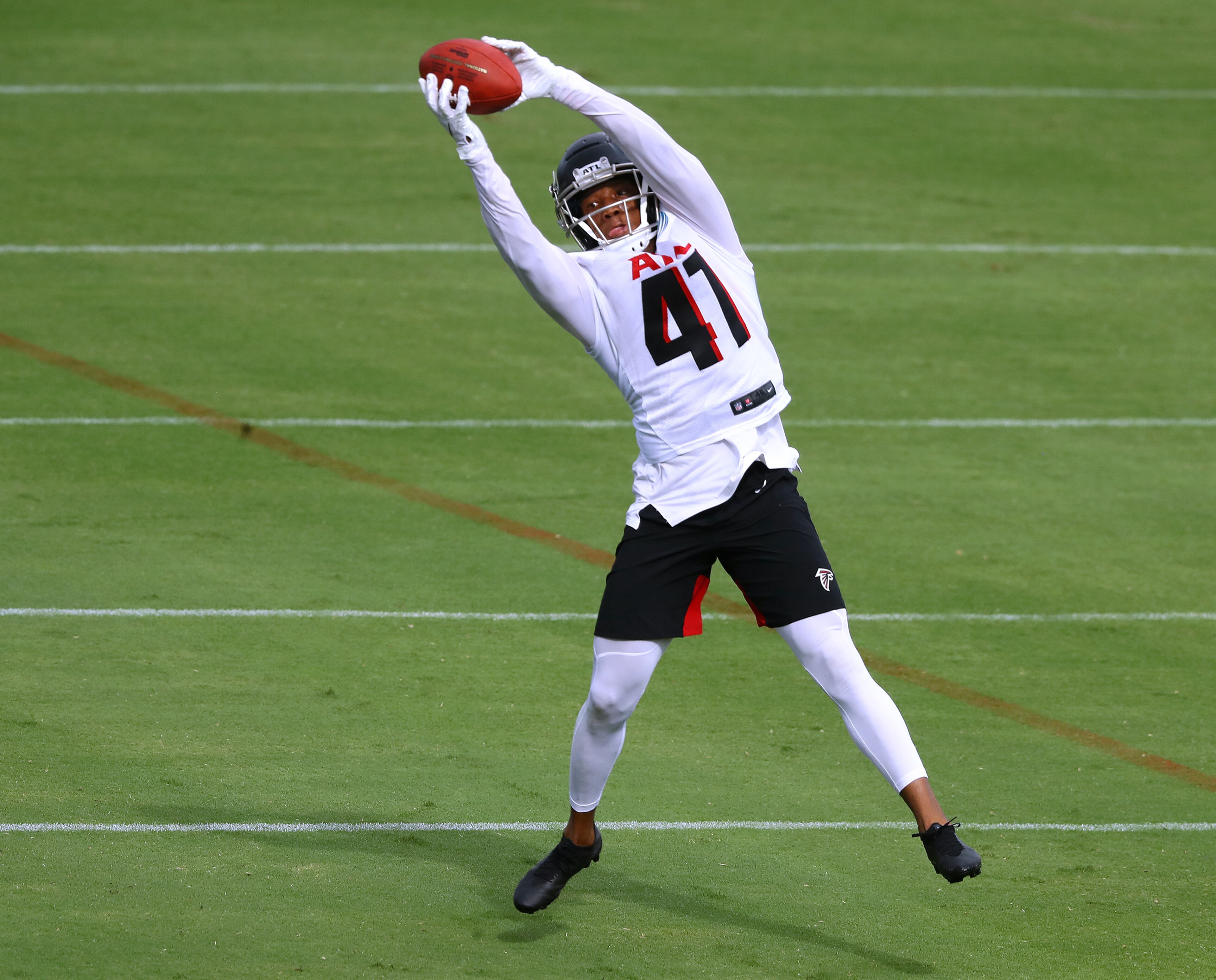 Falcons safety Sharrod Neasman goes up to intercept a pass during training camp on Saturday, August 15, 2020 in Flowery Branch. Curtis Compton ccompton@ajc.com