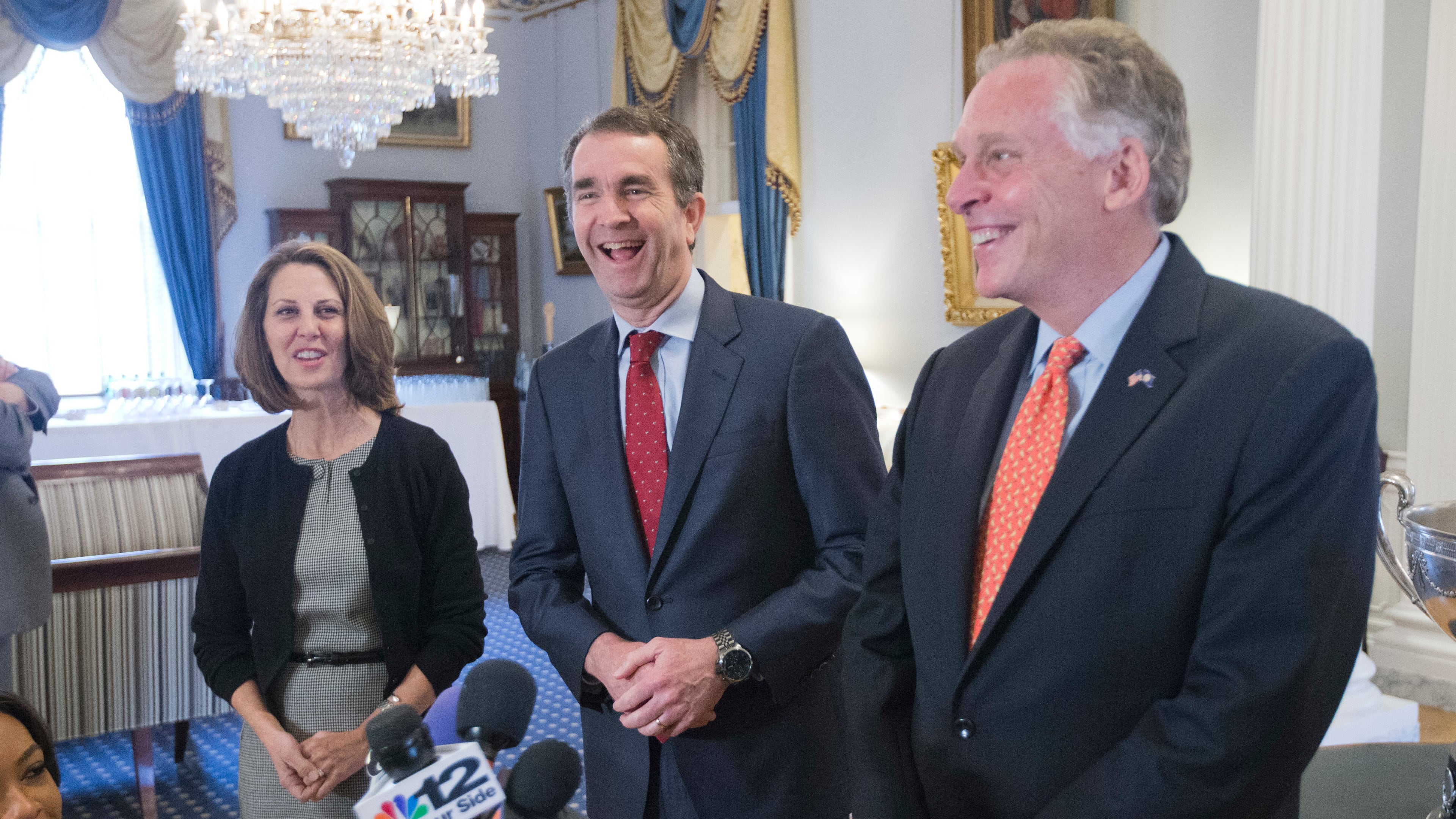 Virginia Gov. Terry McAuliffe, right, shares a laugh with Gov.-elect, Ralph Northam, center, as Pam Northam, left, looks on during a press conference in Richmond, Va., on Wednesday. AP/Steve Helber