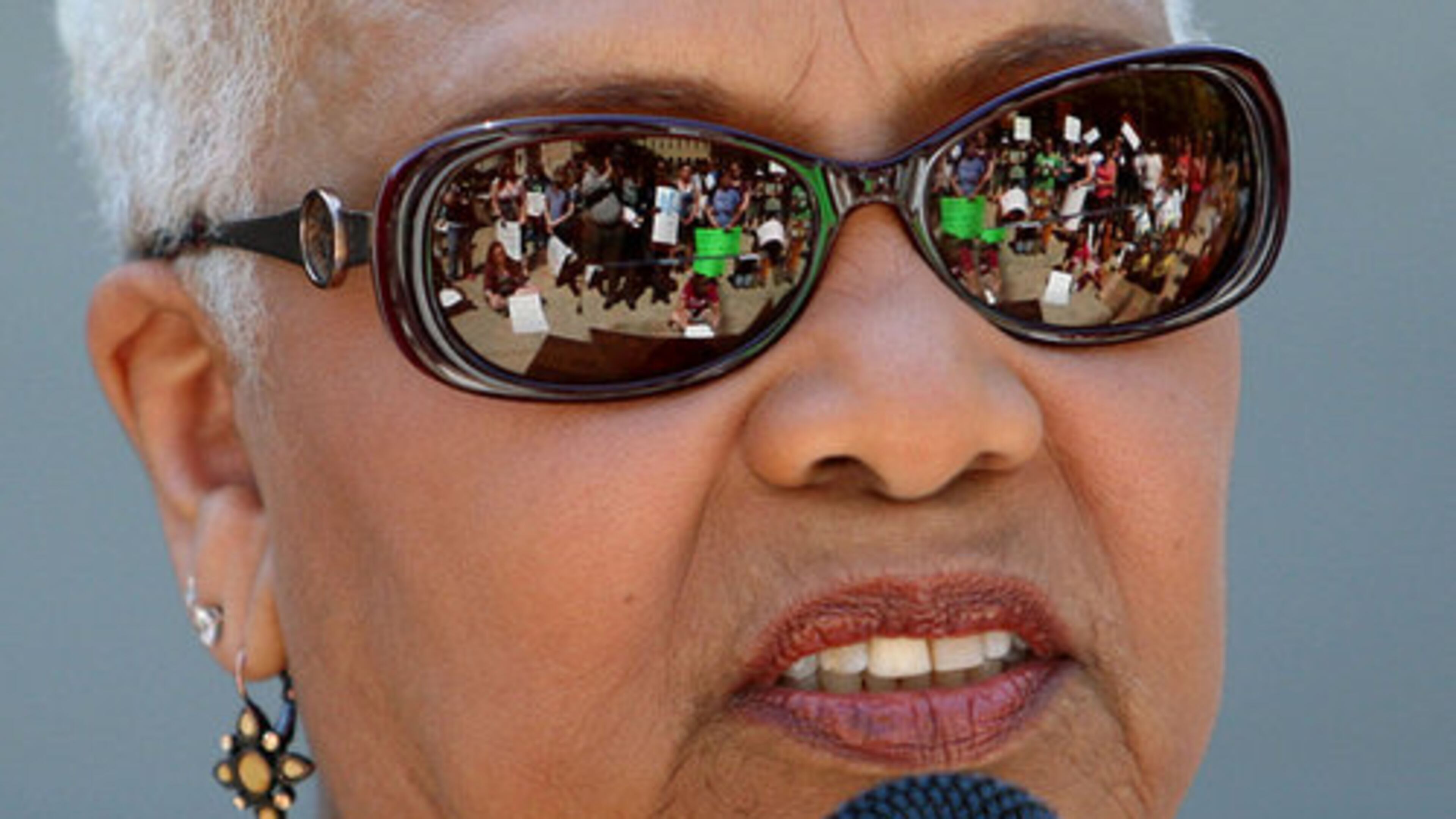 Protestors are shown in the glasses of Sen. Gloria Butler, D-Stone Mountain, as she speaks during the War-on-Women's March on the steps of the Georgia State Capitol. Around 100 people showed up for this rally.