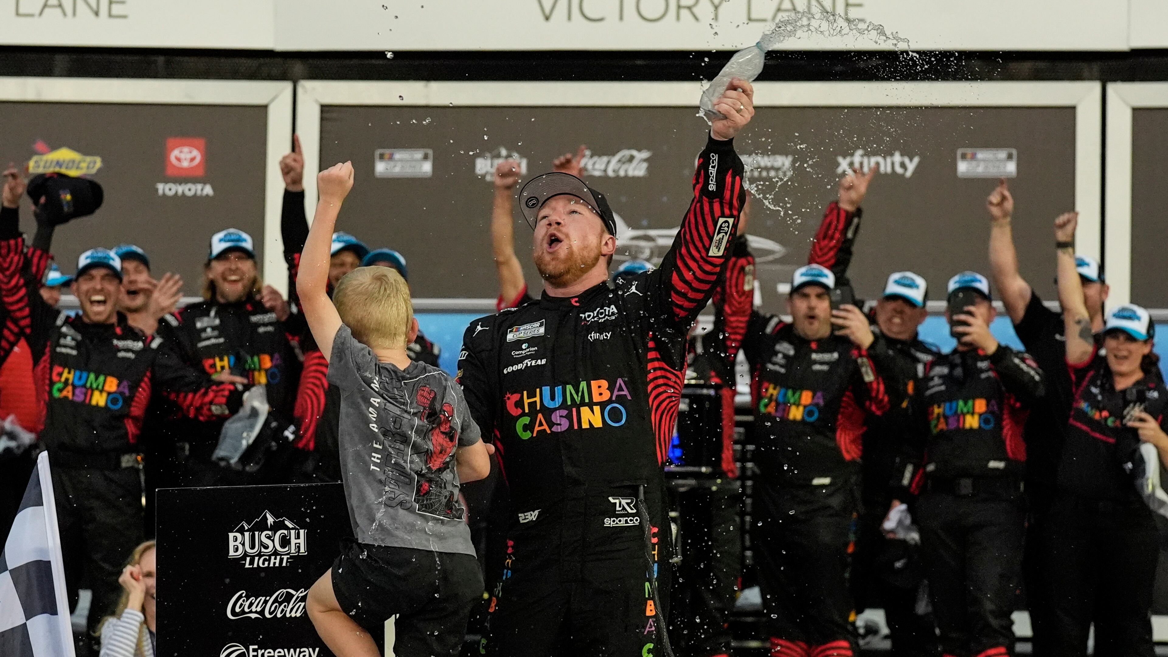 Tyler Reddick, (45) and his son Beau celebrate with the team after winning the NASCAR Daytona 500 auto race at Daytona International Speedway, Sunday, Feb. 15, 2026, in Daytona Beach, Fla. (AP Photo/Mike Stewart)