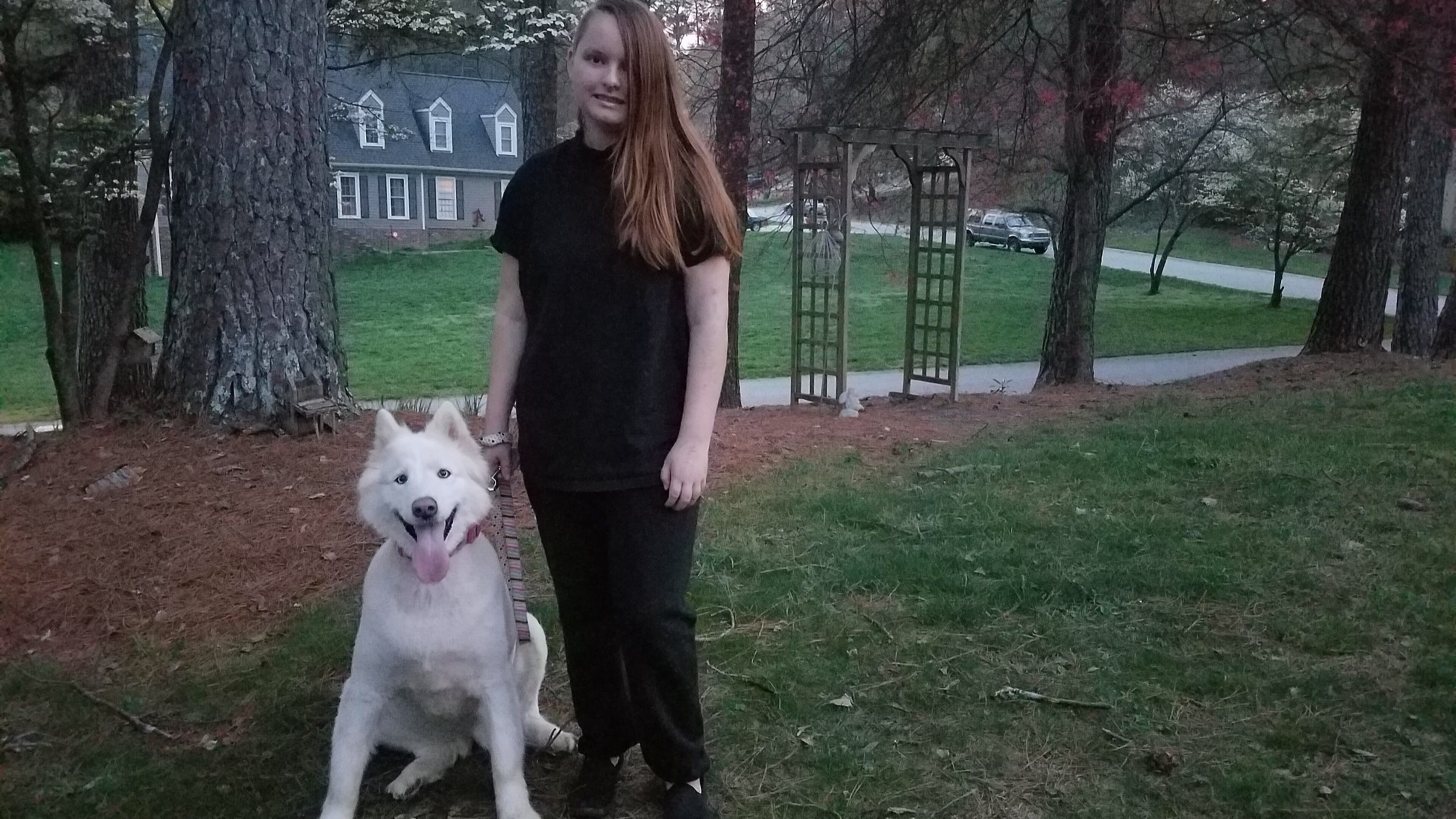 Young author Emily Rose Ross outside her east Cobb home with Balta, the family’s German Shepherd-husky rescue. Her first book, the sci-fi fantasy novel “Blue’s Prophecy,” will be released in May. CONTRIBUTED BY DIANE LORE