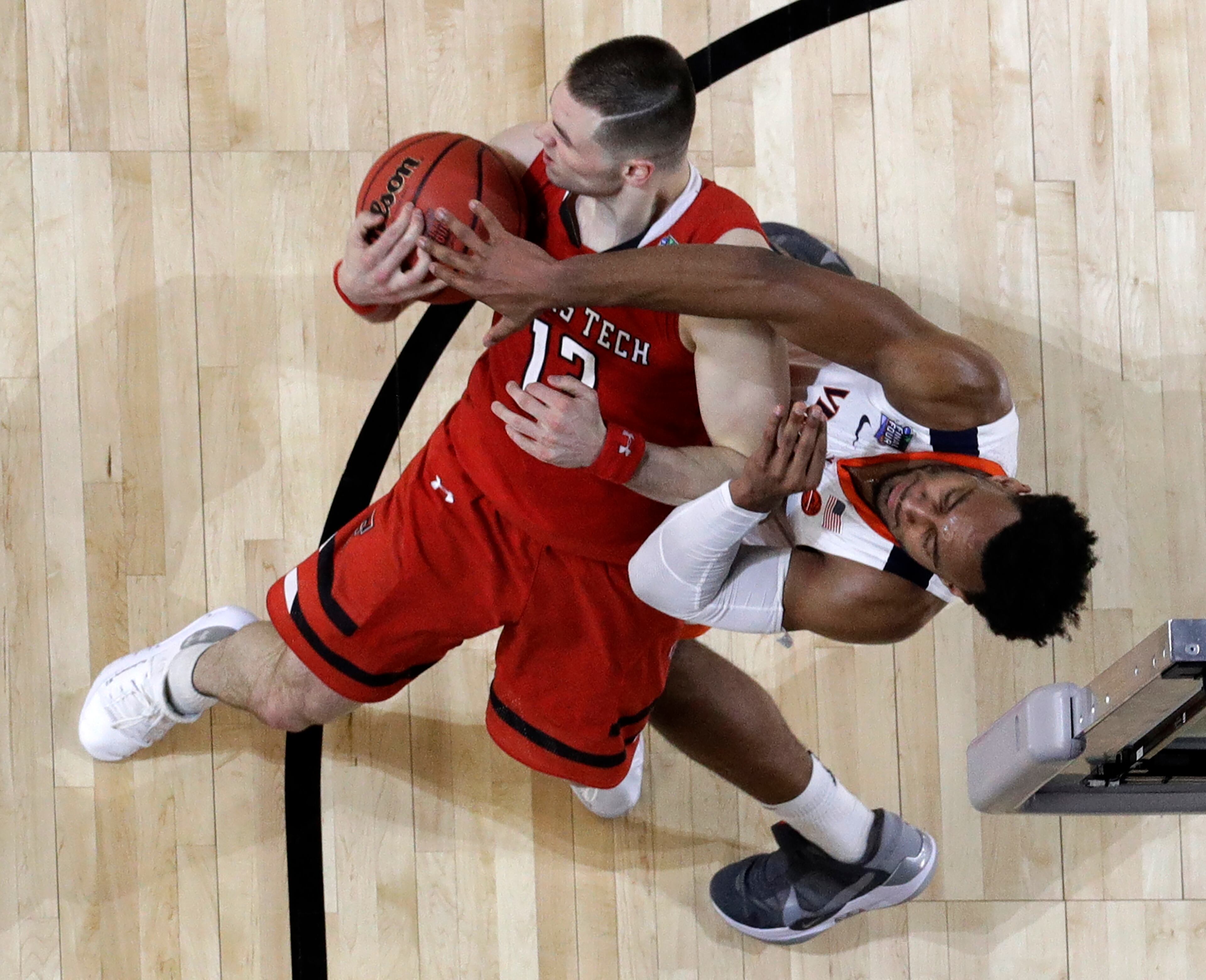 Texas Tech's Matt Mooney (13) and Virginia's Braxton Key battle for a rebound during the second half in the championship of the Final Four NCAA college basketball tournament, Monday, April 8, 2019, in Minneapolis. (AP Photo/David J. Phillip)