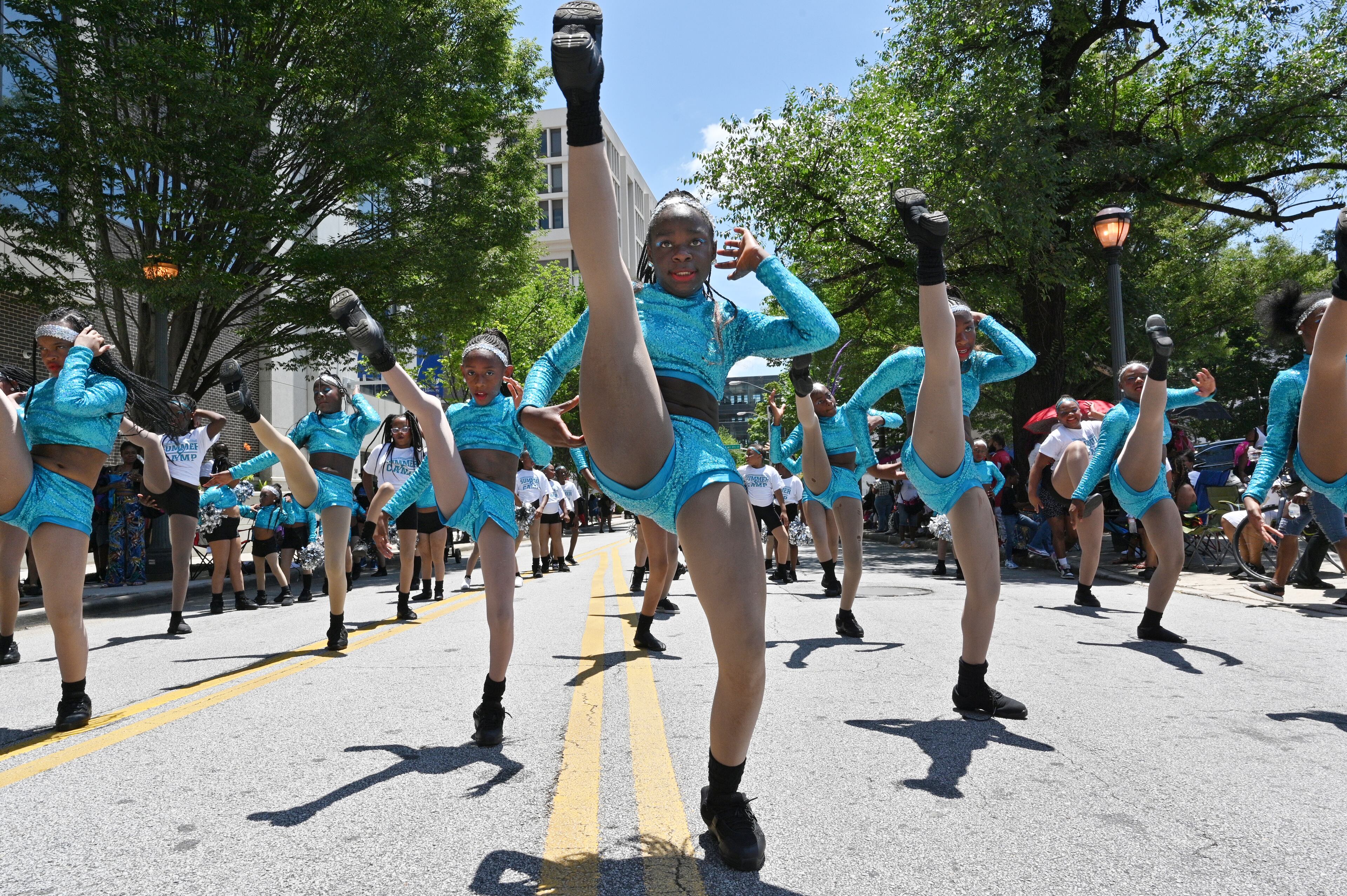 Dancers make their way down on Marietta Street during the Juneteenth Atlanta Black History Parade on Saturday, June 18, 2022. The 10th annual Juneteenth Atlanta Parade & Music Festival is a four-day free music festival that also includes a black history parade. Juneteenth, a June 19 holiday, recognizes the last African American slaves being freed in 1865, more than two years after the Emancipation Proclamation was signed. Now a federal holiday, Juneteenth celebrates African American freedom, history, culture, achievements and more with a variety of commemorative events including history lessons, art, music and empowerment programs. (Hyosub Shin / Hyosub.Shin@ajc.com)
