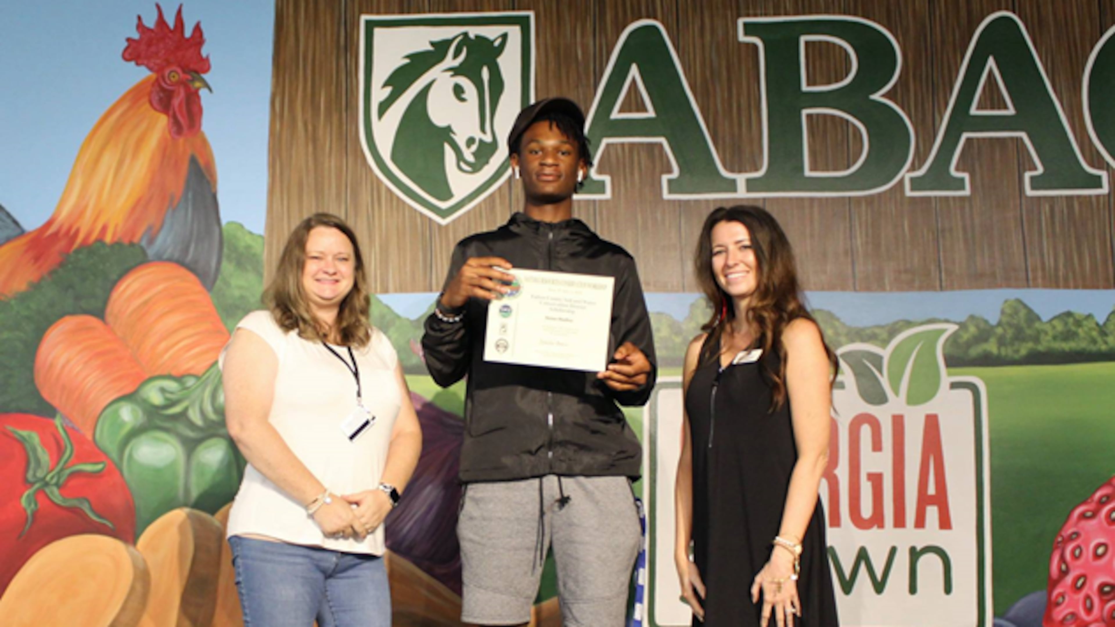 Aman Hadley of Fairburn and a sophomore at Westlake High School received the Fulton County Soil and Water Conservation District Scholarship to attend the Natural Resources Conservation Workshop held at Abraham Baldwin Agricultural College in Tifton. He is pictured with Michelle Boone- NRCW Director (left) and Katie Sponberger- GACD Executive Director.