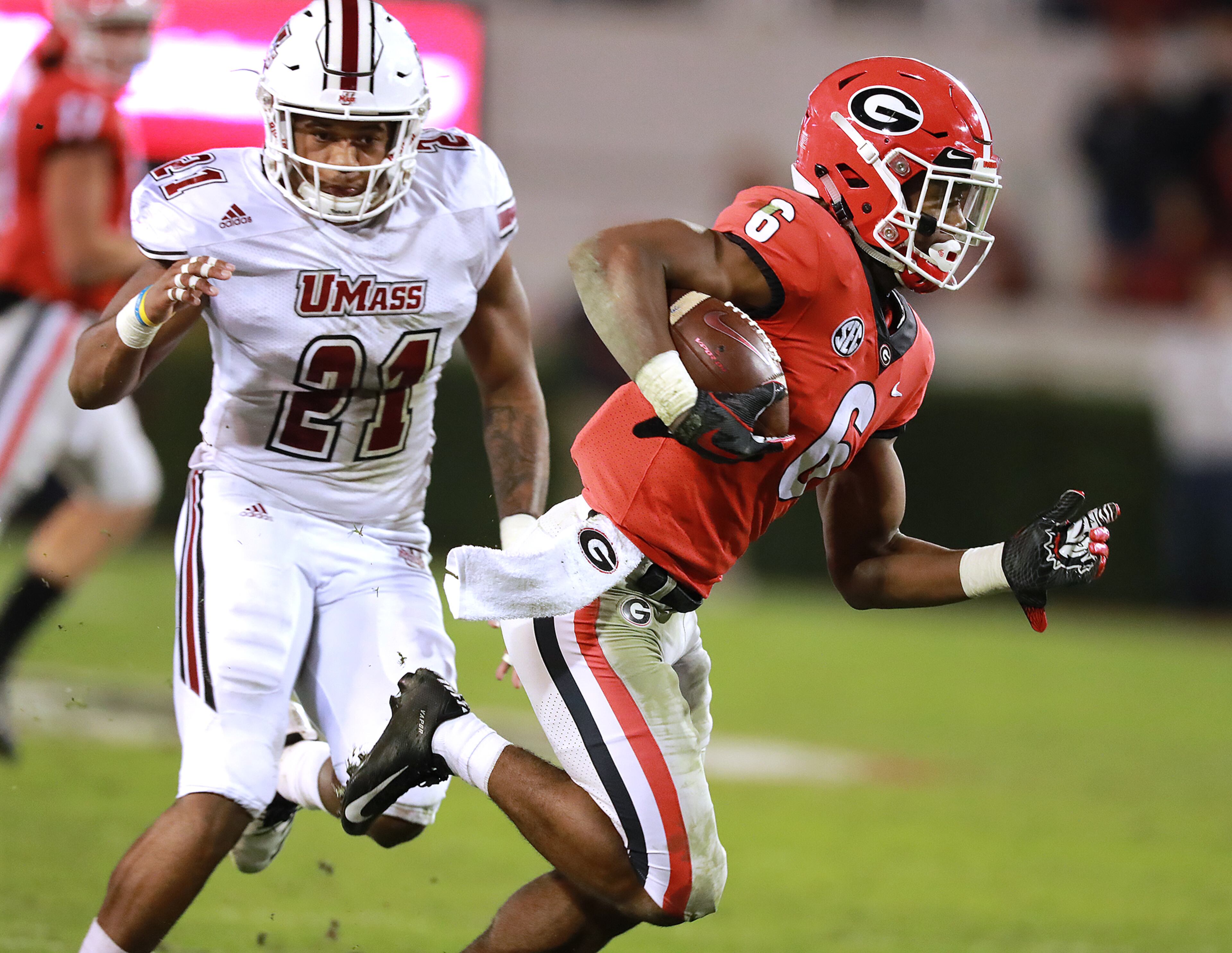 Nov 17, 2018 Athens: Georgia tailback James Cook breaks away from Massachusetts defender Tyshaun Ingram for a 27-yard touchdown and a 66-20 lead during the fourth quarter in a NCAA college football game on Saturday, Nov. 17, 2018, in Athens. Georgia beat Massachusetts 66-27. Curtis Compton/ccompton@ajc.com