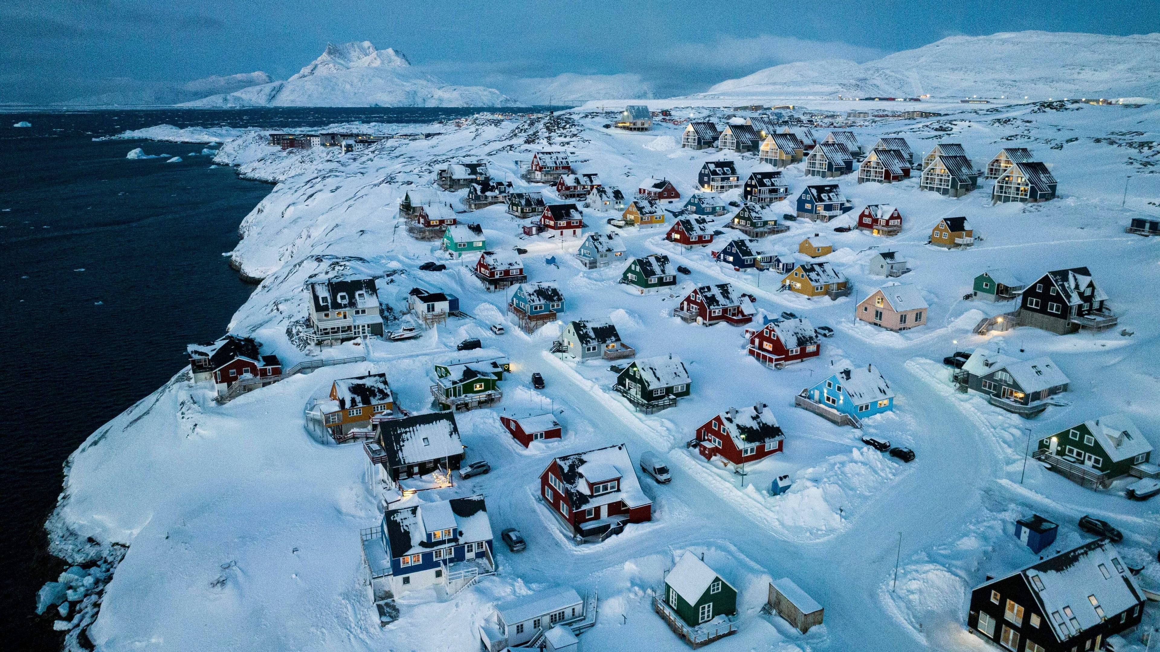 FILE - Houses covered in snow are seen on the coast of a sea inlet of Nuuk, Greenland, Friday, March 7, 2025. (AP Photo/Evgeniy Maloletka, File)