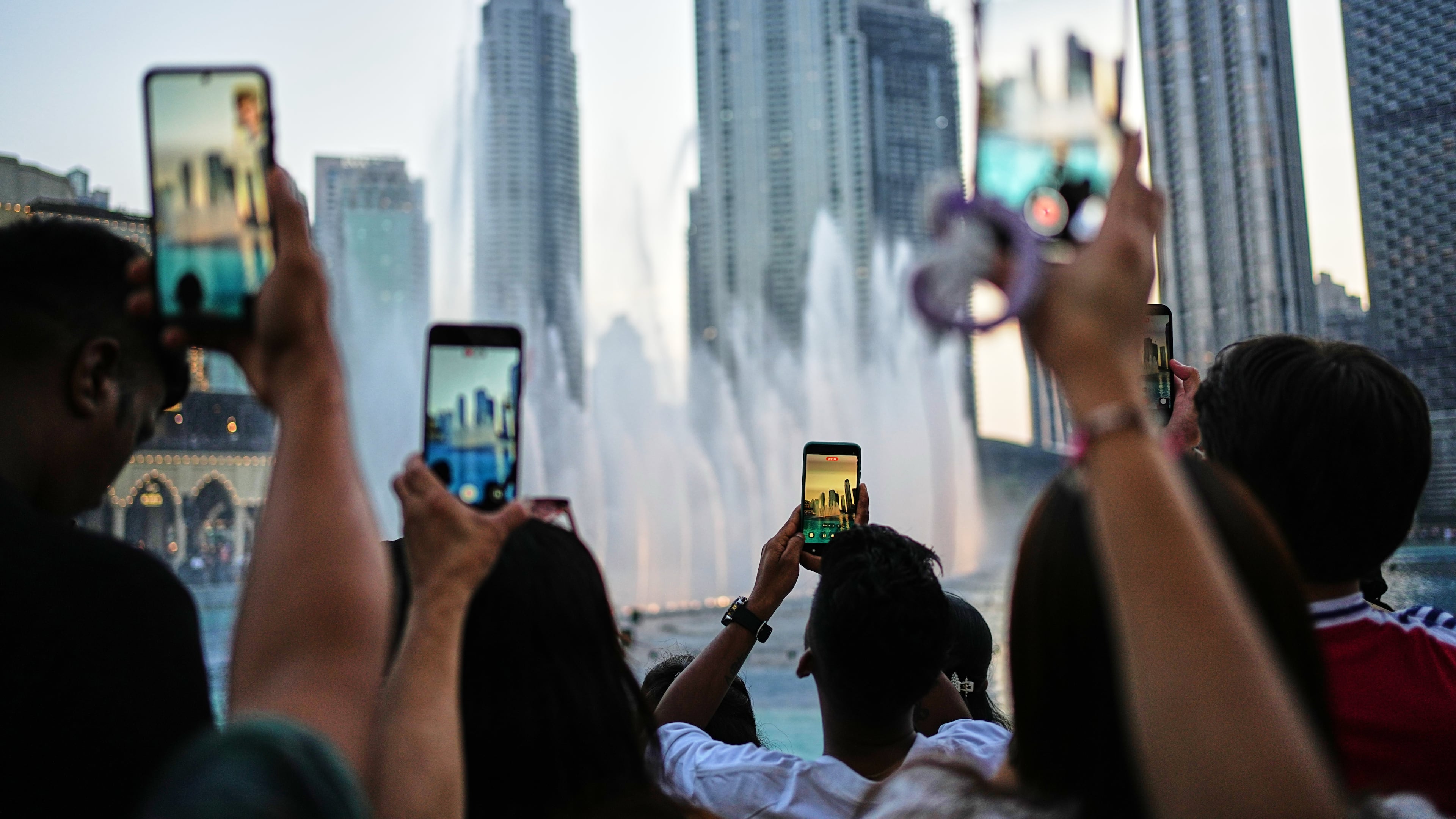 People photograph the Dubai Fountain with skyscrapers in the background outside Dubai Mall on the first day of the Eid al-Adha holiday in Dubai, United Arab Emirates, Wednesday, May 27, 2026. (AP Photo/Fatima Shbair)
