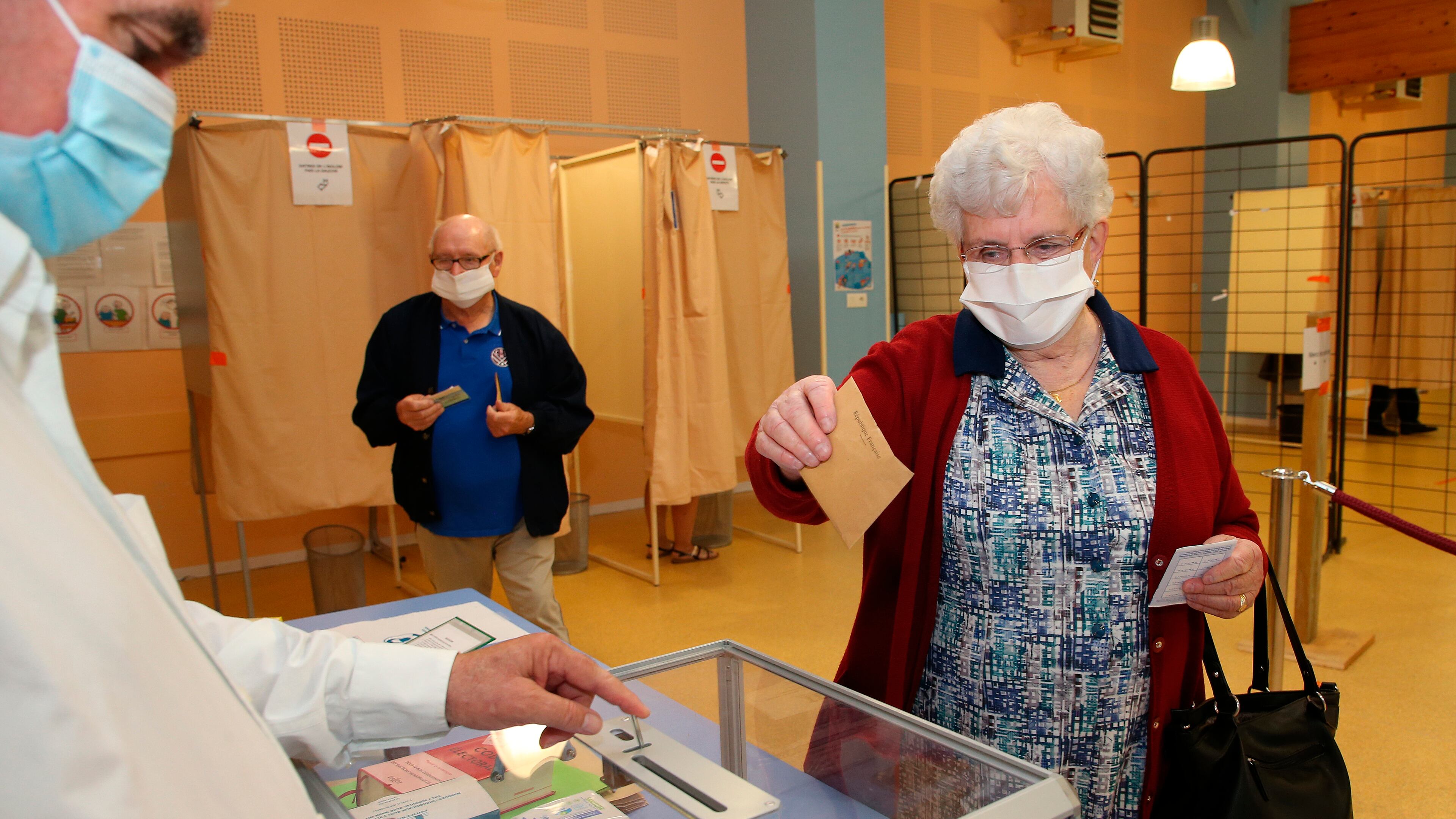 A woman casts a vote during the second round of municipal elections in France.