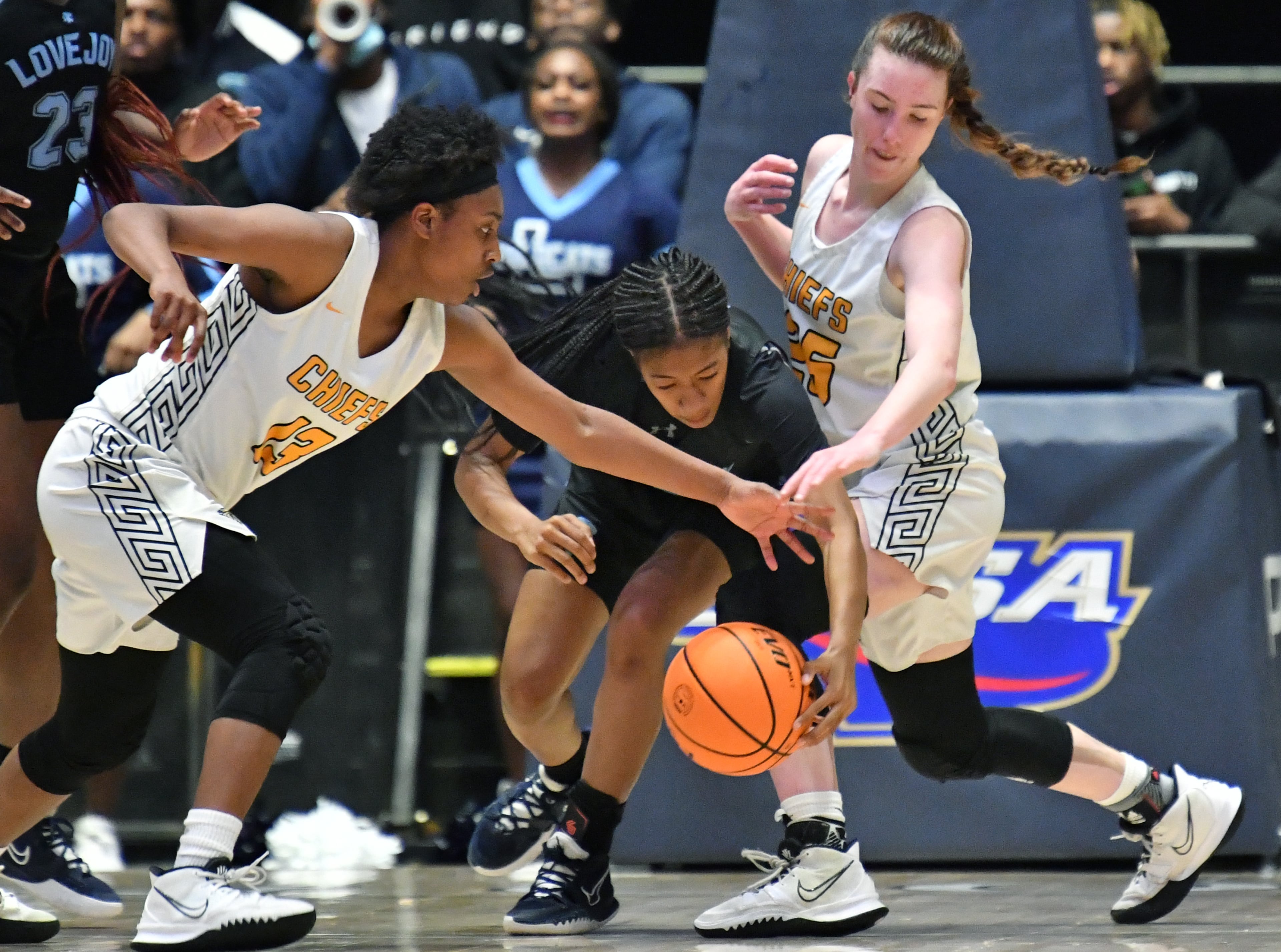 Lovejoy's Camiah Muldrow (center) fights for a loose ball against Sequoyah's A'ryn Jackson (left) and Elle Blatchford (right) during the Class 6A girls state championship game Friday in Macon. (Hyosub Shin/hshin@ajc.com)