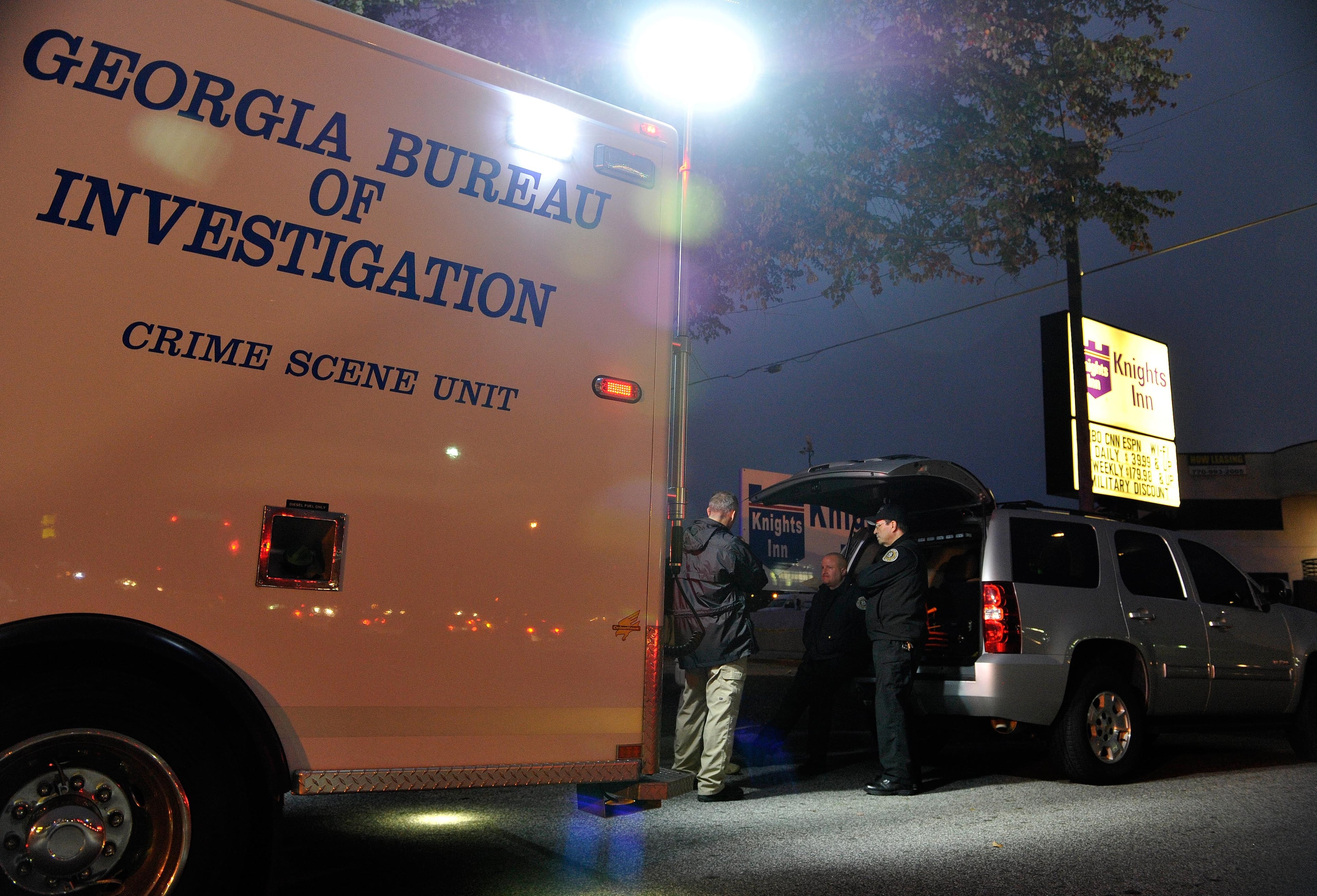 Norcross police and the GBI investigate an officer-involved shooting at the Fusion Event Hall parking lot next to a Knights Inn motel and the adjacent Waffle House at Indian Trail Road and Brook Hollow Parkway on Monday, Oct. 13, 2014, in Norcross, Ga.