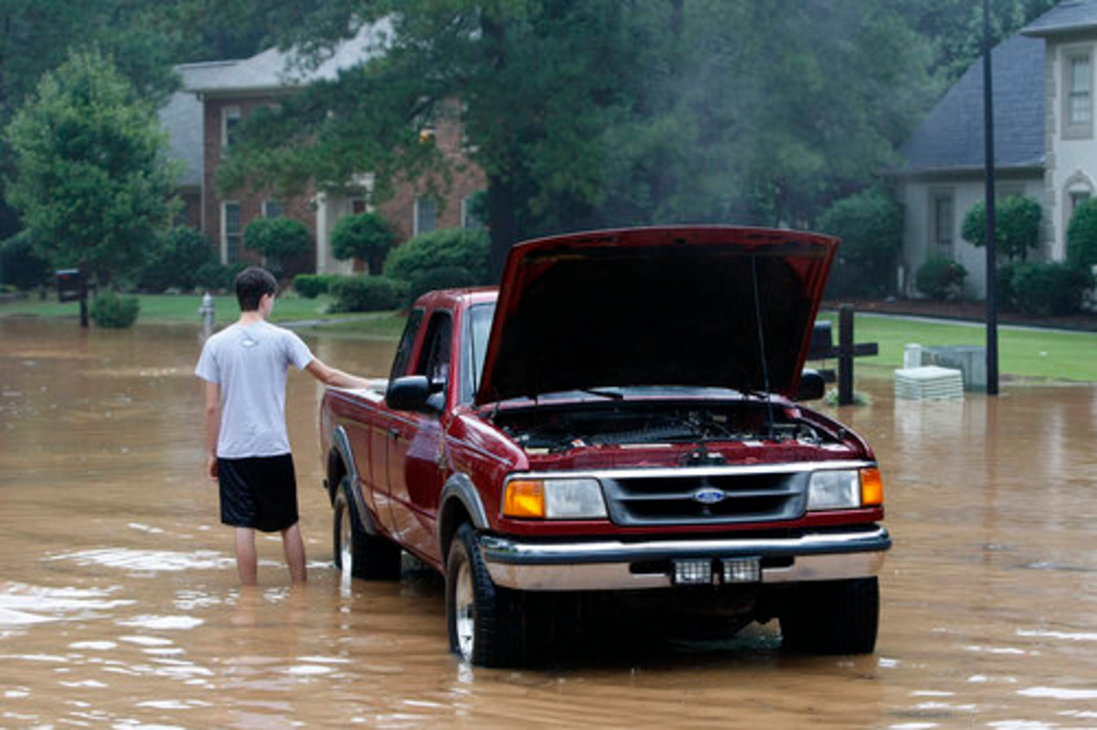 Jason Wansor's truck stalled out while trying to make it through rising flood waters from the Yellow River on Silver Creek Run SW in the Connemara Subdivision near Lilburn.