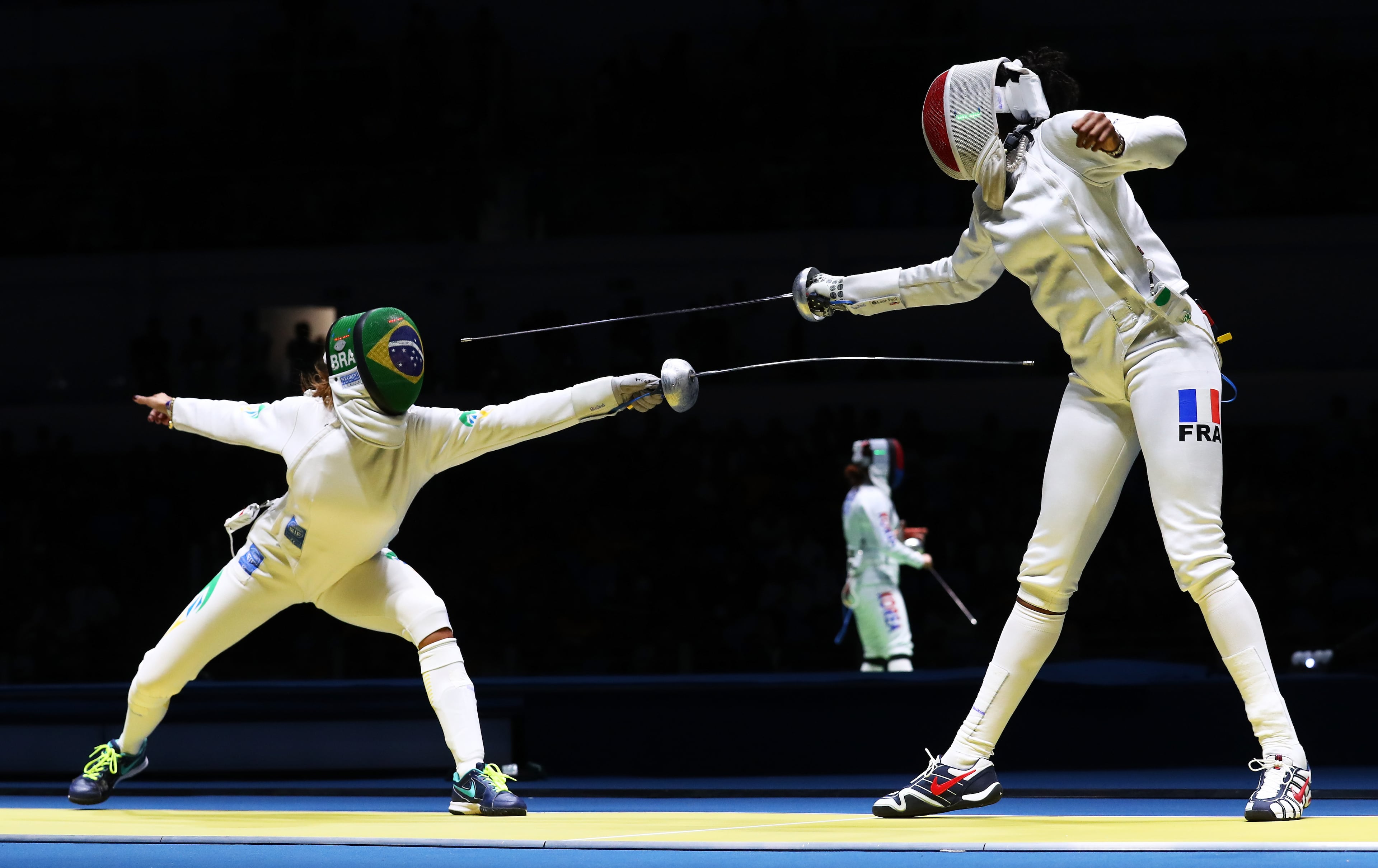 RIO DE JANEIRO, BRAZIL - AUGUST 06: MF Candassamy of France (L) in action against Nathalie Moellhausen (R) of Brazil during the Women’s Individual Epee: round of 16 on Day 1 of the Rio 2016 Olympic Games at Carioca Arena 3 on August 6, 2016 in Rio de Janeiro, Brazil. (Photo by Ryan Pierse/Getty Images)