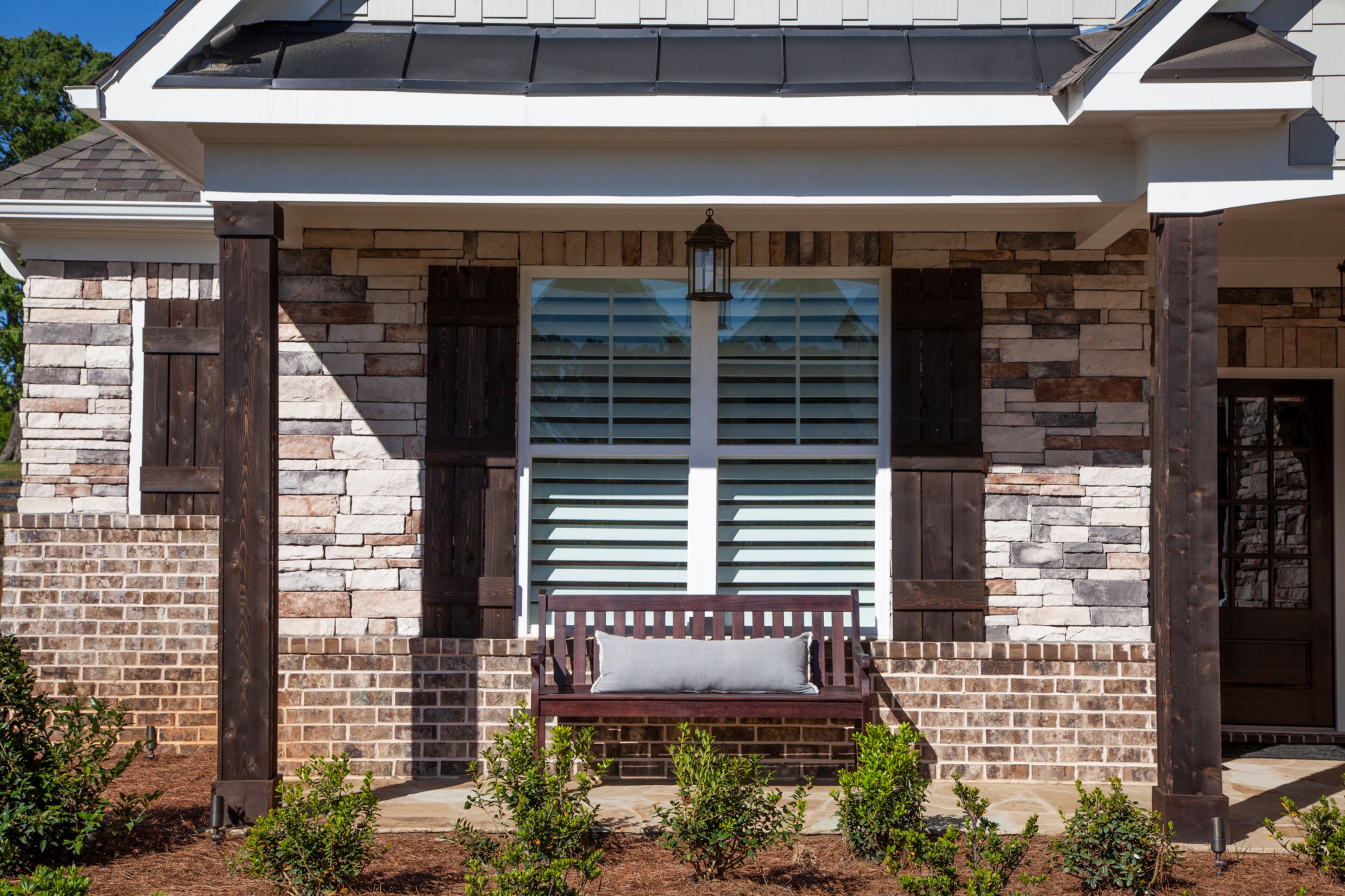 Stone, shake siding and cedar mix on the exterior of the new Cobb County home.