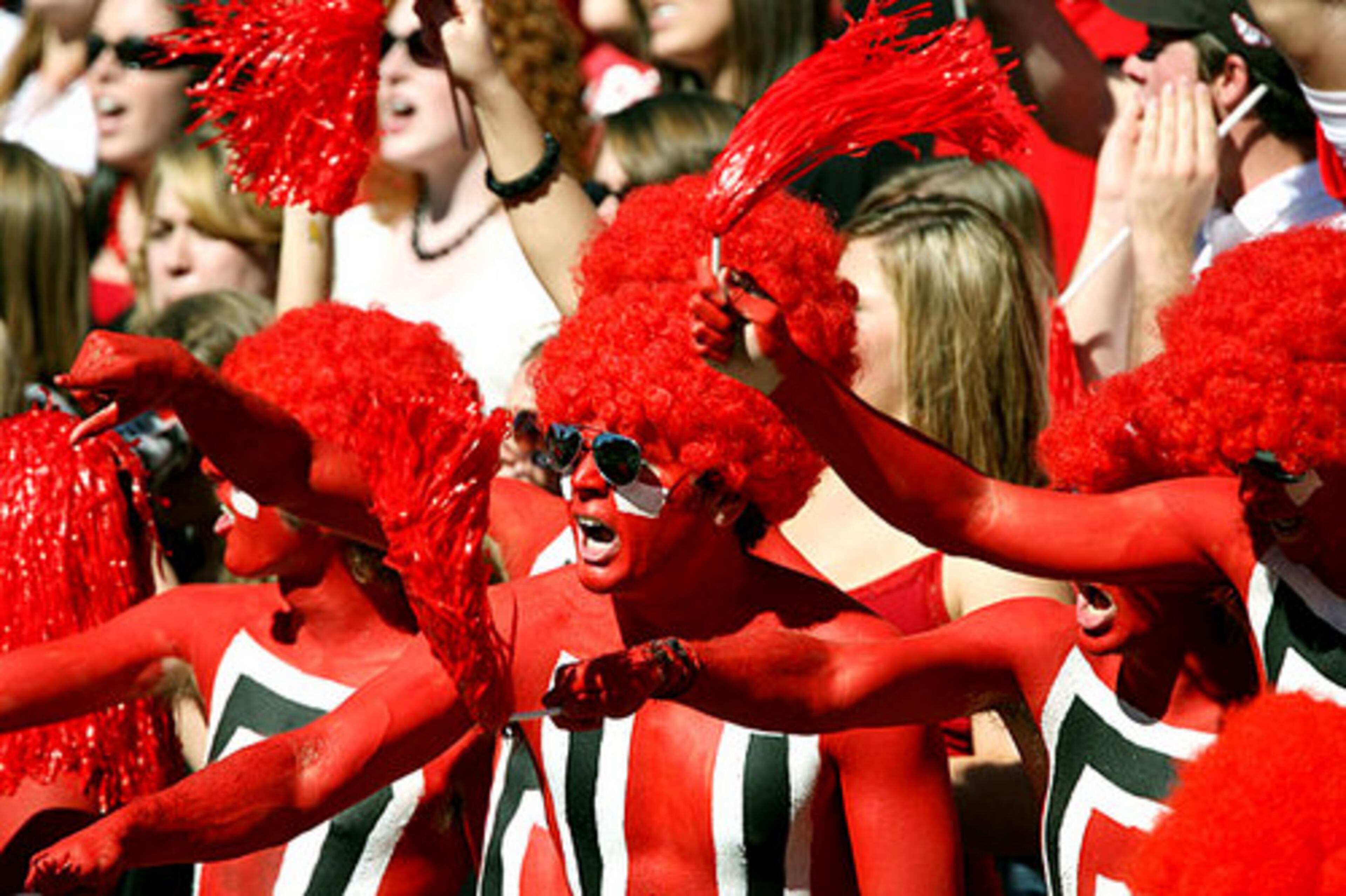Being painted Red and Black, Georgia fans cheer their team on to a homecoming victory over the Troy Trojans in 2007. Image Credit: April Kooy.